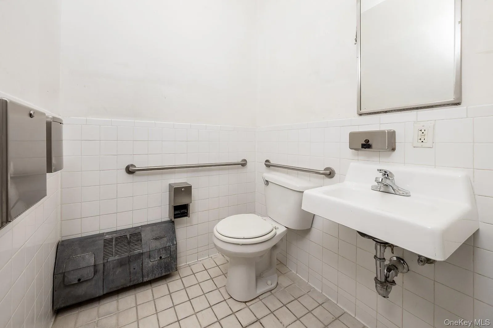 Bathroom wainscoting, tile patterned flooring, and toilet Bathroom wainscoting, tile patterned flooring, and toilet