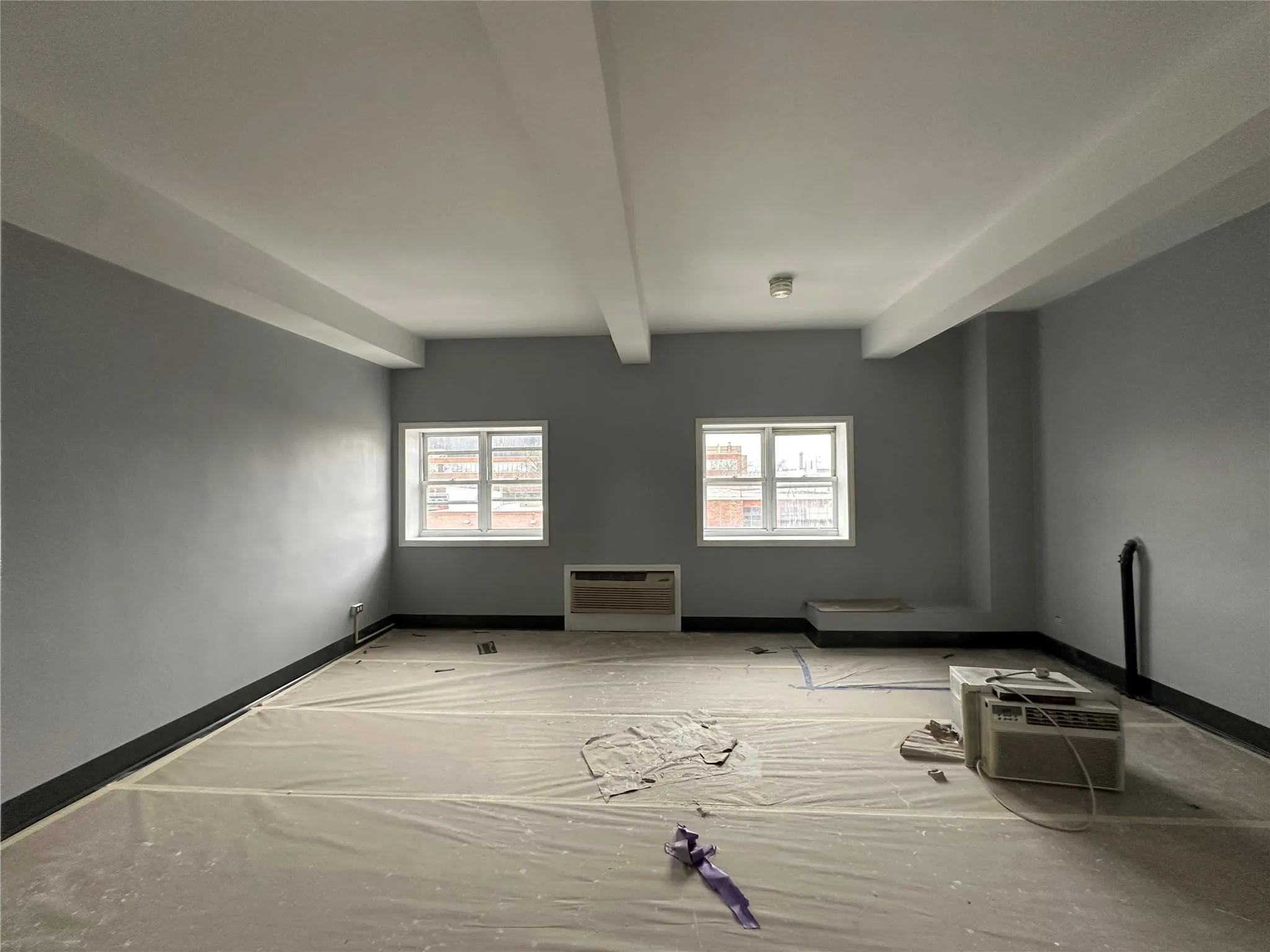 Unfurnished room featuring a wall mounted air conditioner, baseboards, and a wall unit AC Unfurnished room featuring a wall mounted air conditioner, baseboards, and a wall unit AC