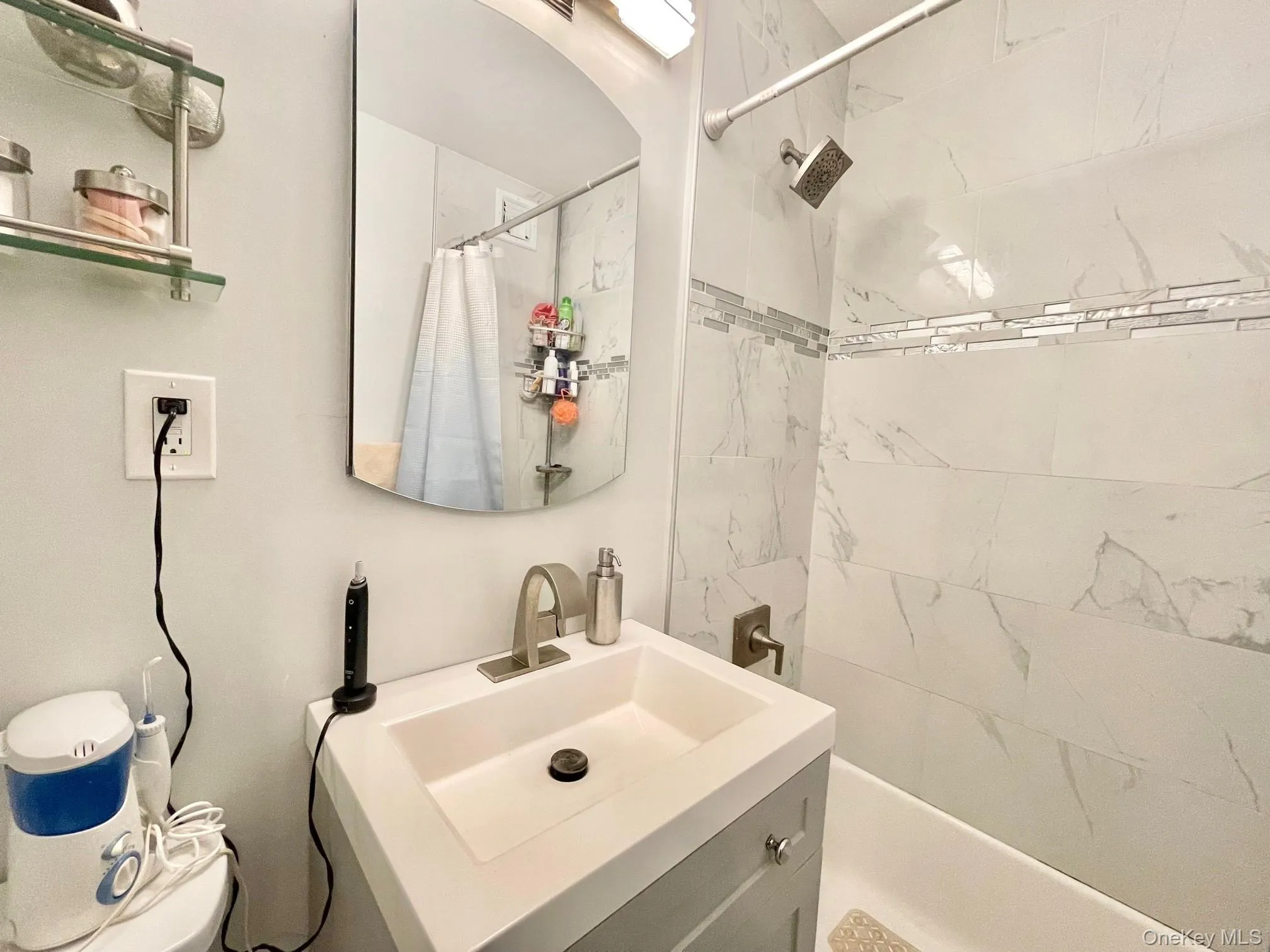 Bathroom featuring shower / bath combo with shower curtain and vanity Bathroom featuring shower / bath combo with shower curtain and vanity