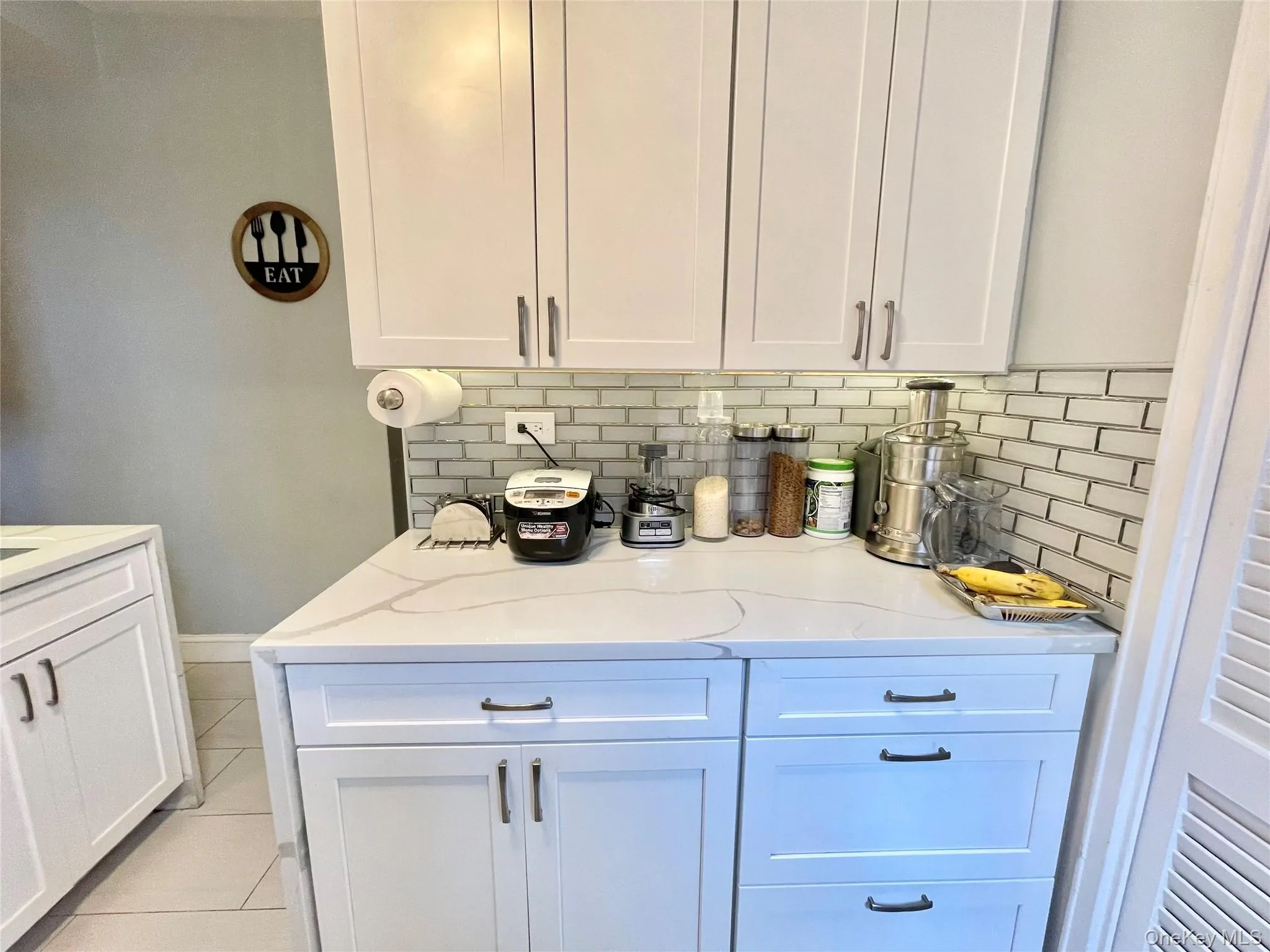 Bar featuring tasteful backsplash and light tile patterned floors Bar featuring tasteful backsplash and light tile patterned floors
