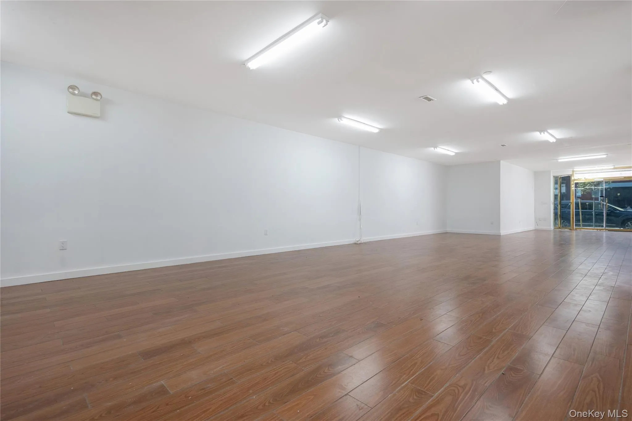 Unfurnished room featuring wood finished floors and baseboards Unfurnished room featuring wood finished floors and baseboards