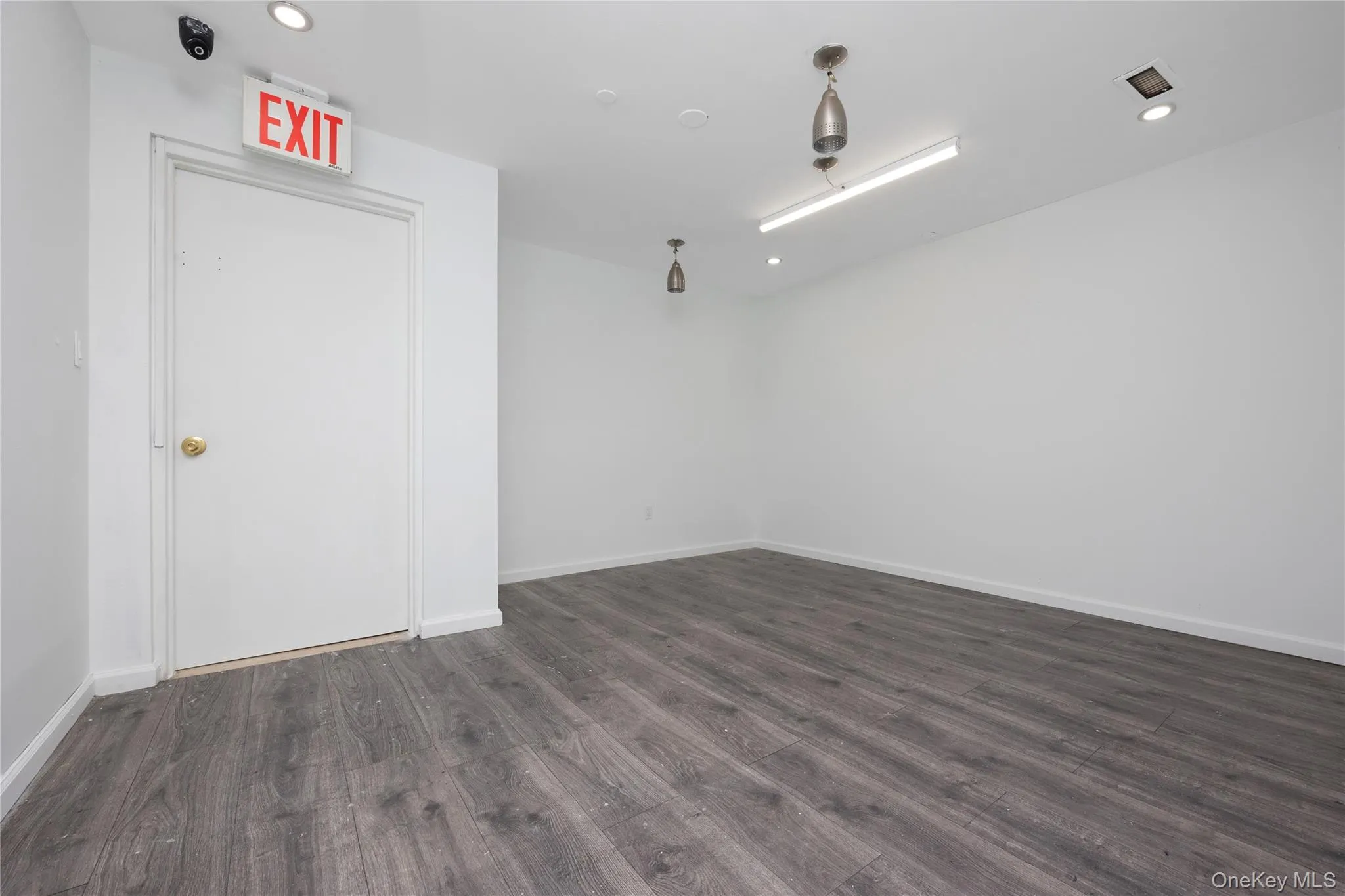 Unfurnished room featuring dark wood-style flooring and recessed lighting Unfurnished room featuring dark wood-style flooring and recessed lighting