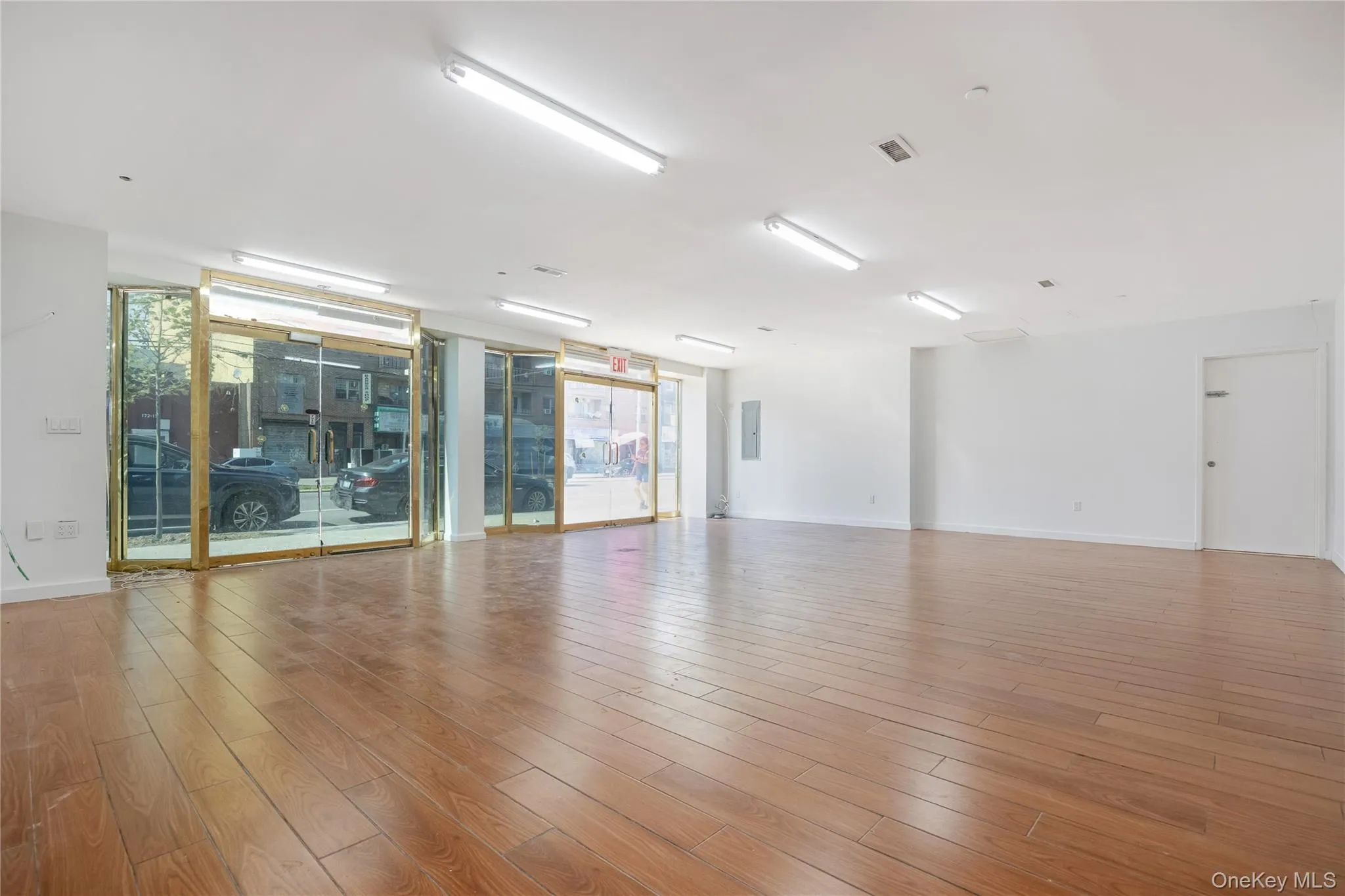 Empty room featuring healthy amount of natural light and wood finished floors Empty room featuring healthy amount of natural light and wood finished floors