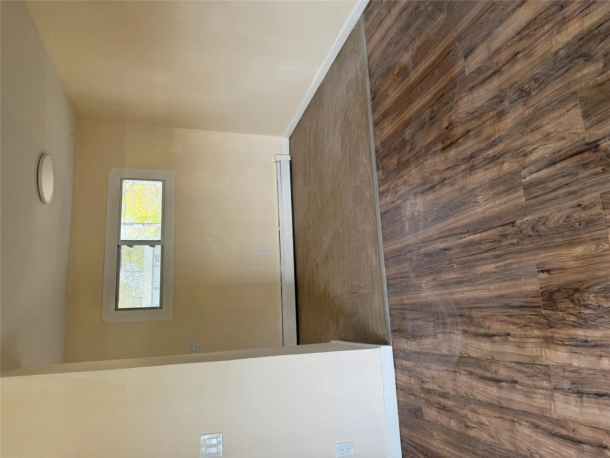 Empty room featuring baseboards, baseboard heating, and wood finished floors Empty room featuring baseboards, baseboard heating, and wood finished floors