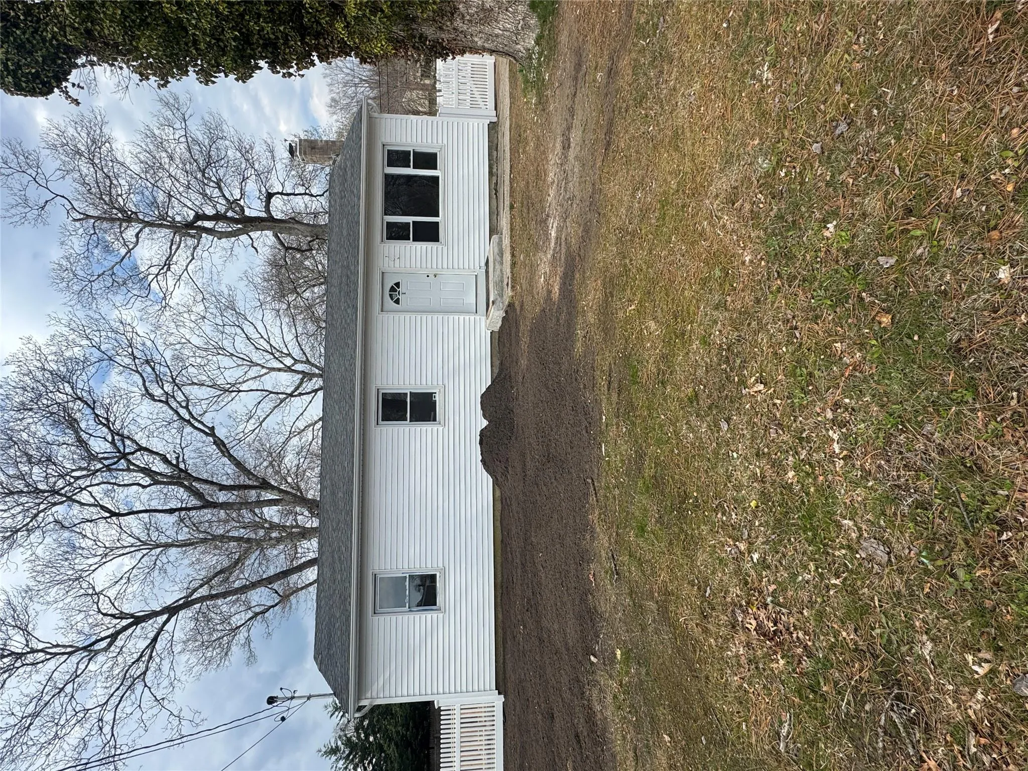 View of front of home featuring a chimney and fence View of front of home featuring a chimney and fence
