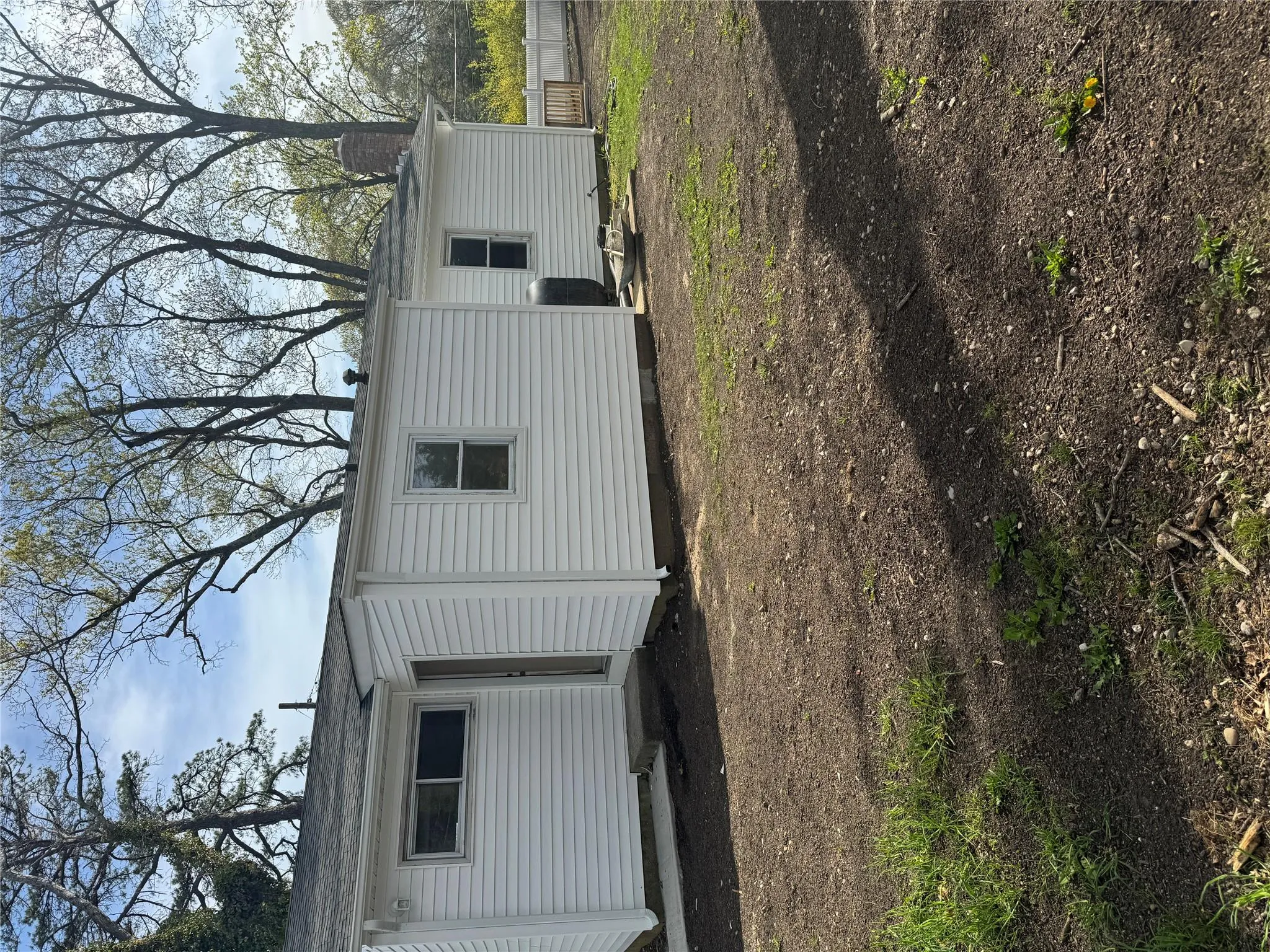 Back of house featuring fence and a chimney Back of house featuring fence and a chimney