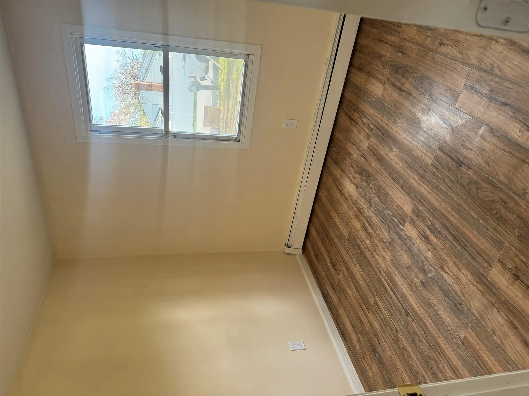 Empty room featuring baseboards, a baseboard heating unit, and wood finished floors Empty room featuring baseboards, a baseboard heating unit, and wood finished floors