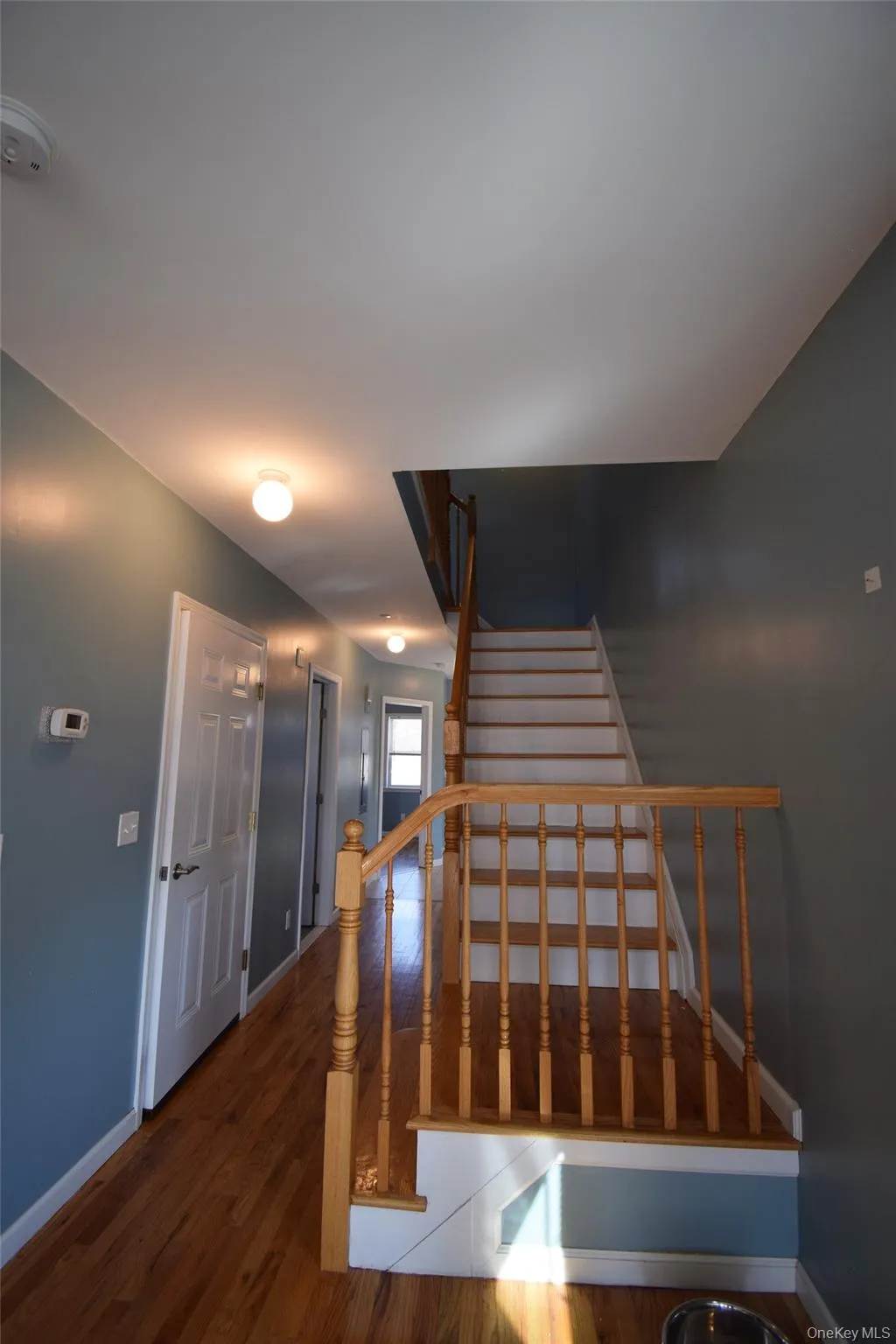 Staircase featuring baseboards and wood finished floors Staircase featuring baseboards and wood finished floors