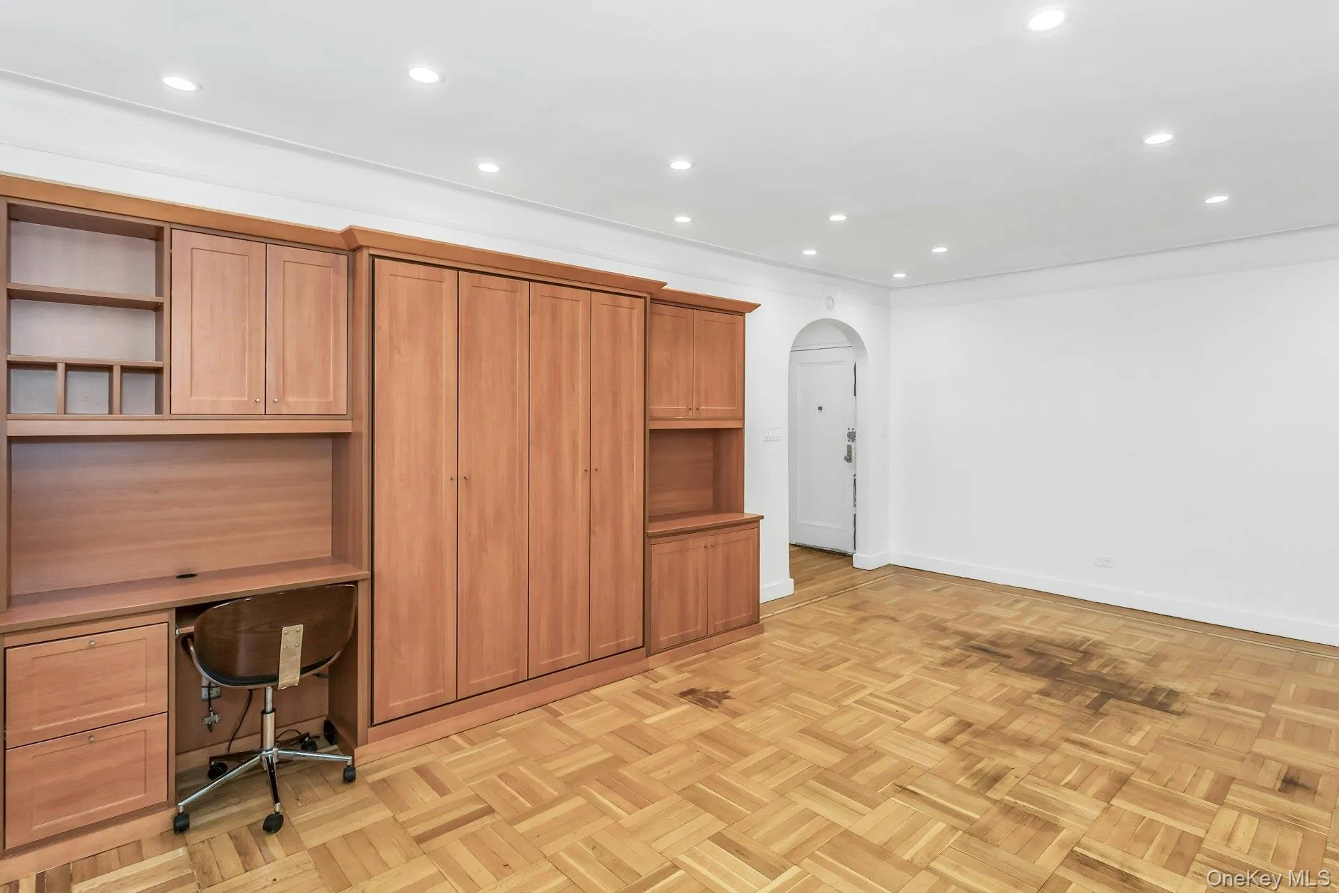 Unfurnished office with arched walkways, baseboards, and recessed lighting Unfurnished office with arched walkways, baseboards, and recessed lighting