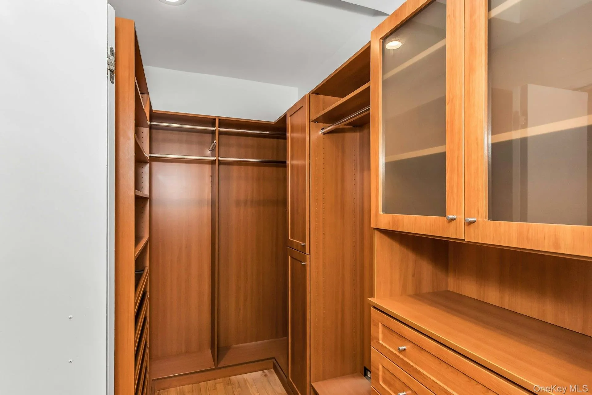 Spacious closet featuring light wood-type flooring Spacious closet featuring light wood-type flooring