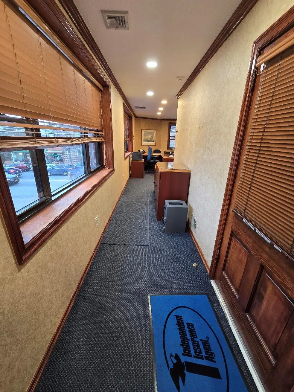Corridor with dark carpet, a textured wall, and crown molding Corridor with dark carpet, a textured wall, and crown molding