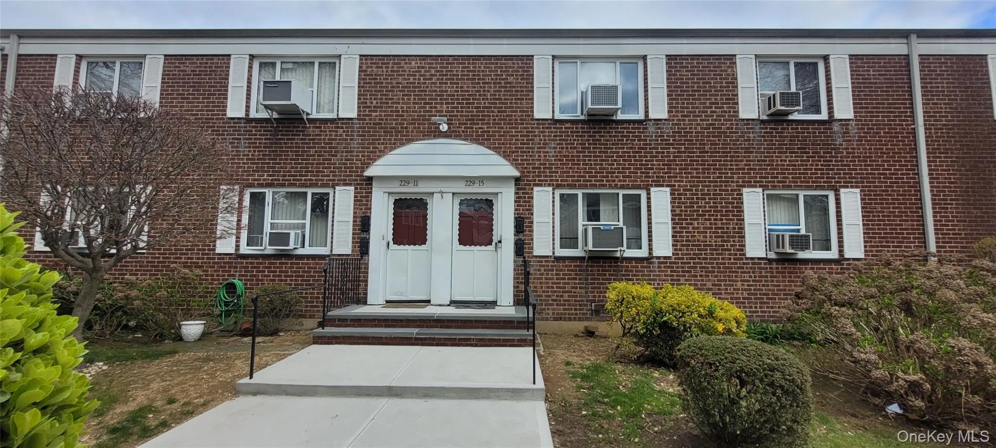 View of front of home featuring brick siding and cooling unit View of front of home featuring brick siding and cooling unit