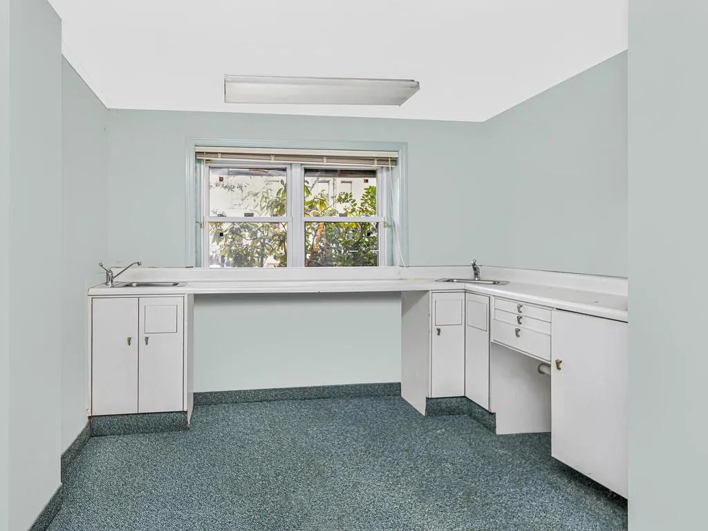 Unfurnished office with baseboards and a sink Unfurnished office with baseboards and a sink