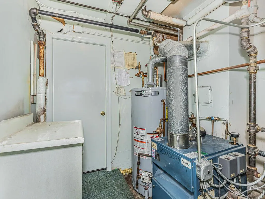 Utility room with a heating unit and gas water heater Utility room with a heating unit and gas water heater