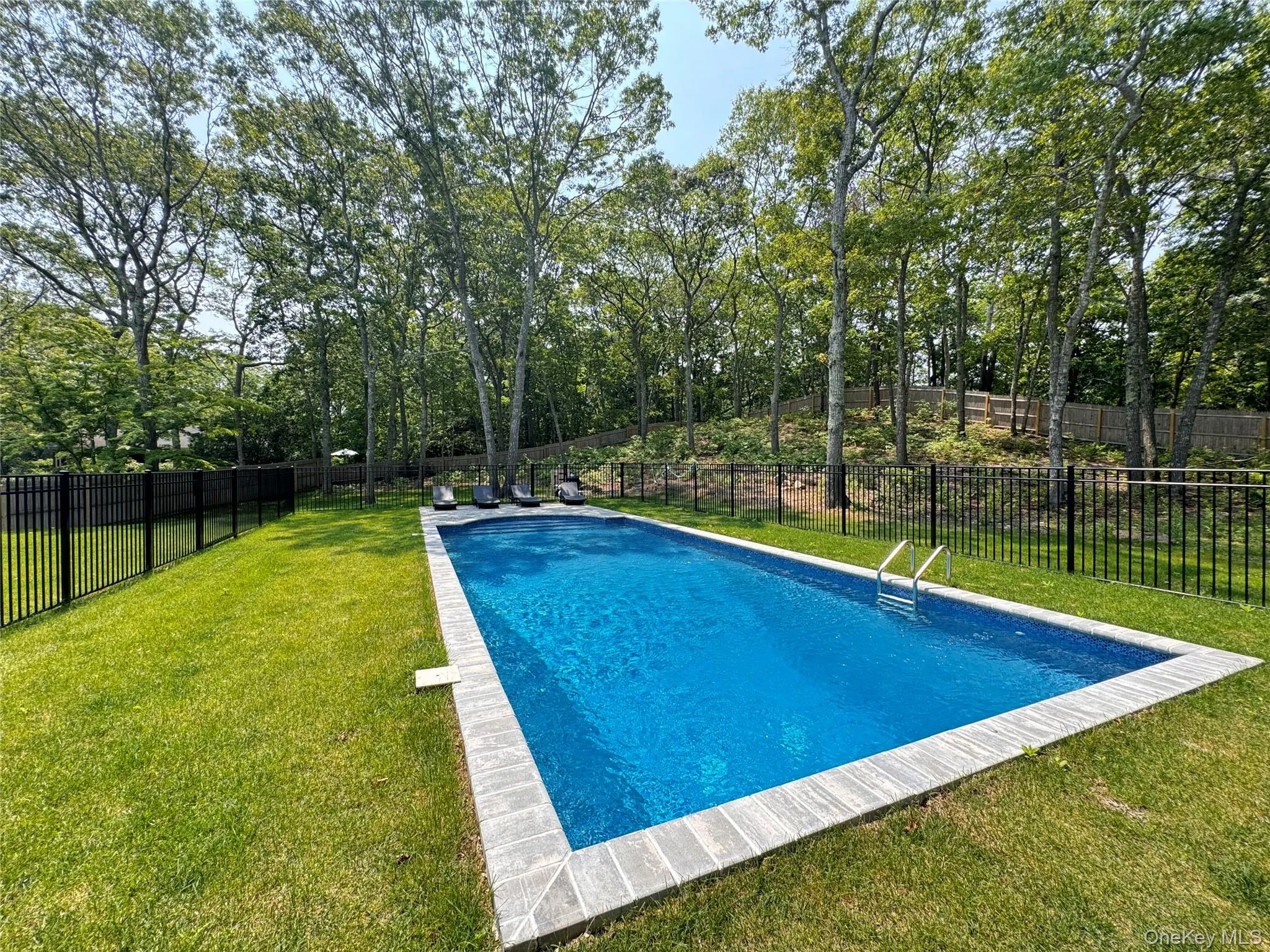 View of swimming pool with a fenced backyard View of swimming pool with a fenced backyard