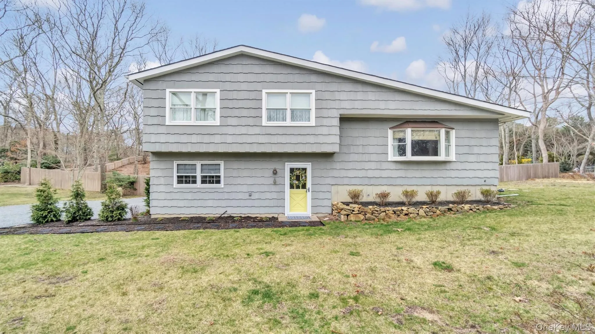 View of front of house featuring fence and a front lawn View of front of house featuring fence and a front lawn
