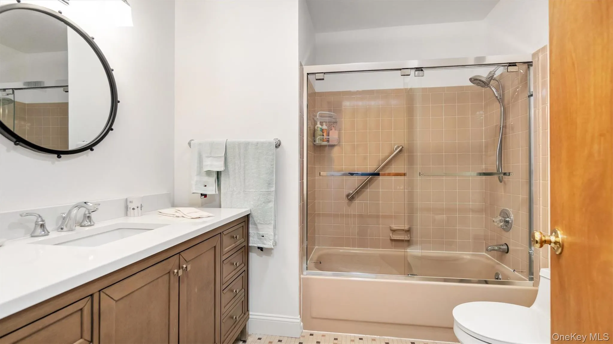 Bathroom with toilet, vanity, and bathtub / shower combination Bathroom with toilet, vanity, and bathtub / shower combination