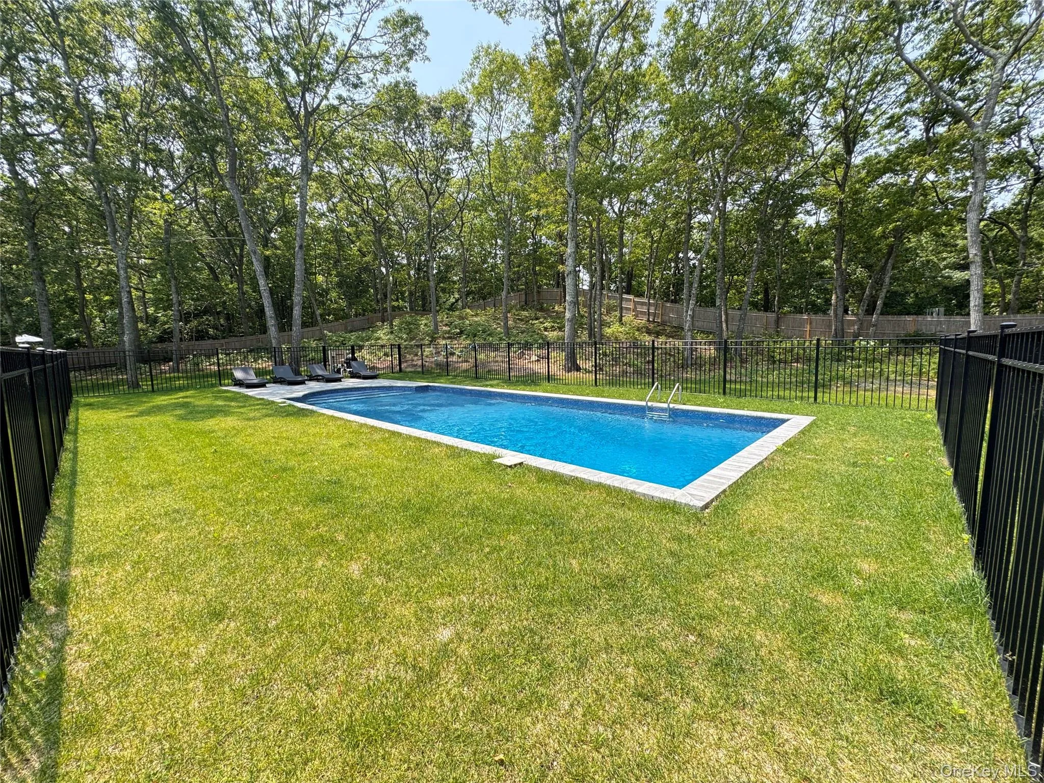 View of pool featuring a fenced backyard View of pool featuring a fenced backyard