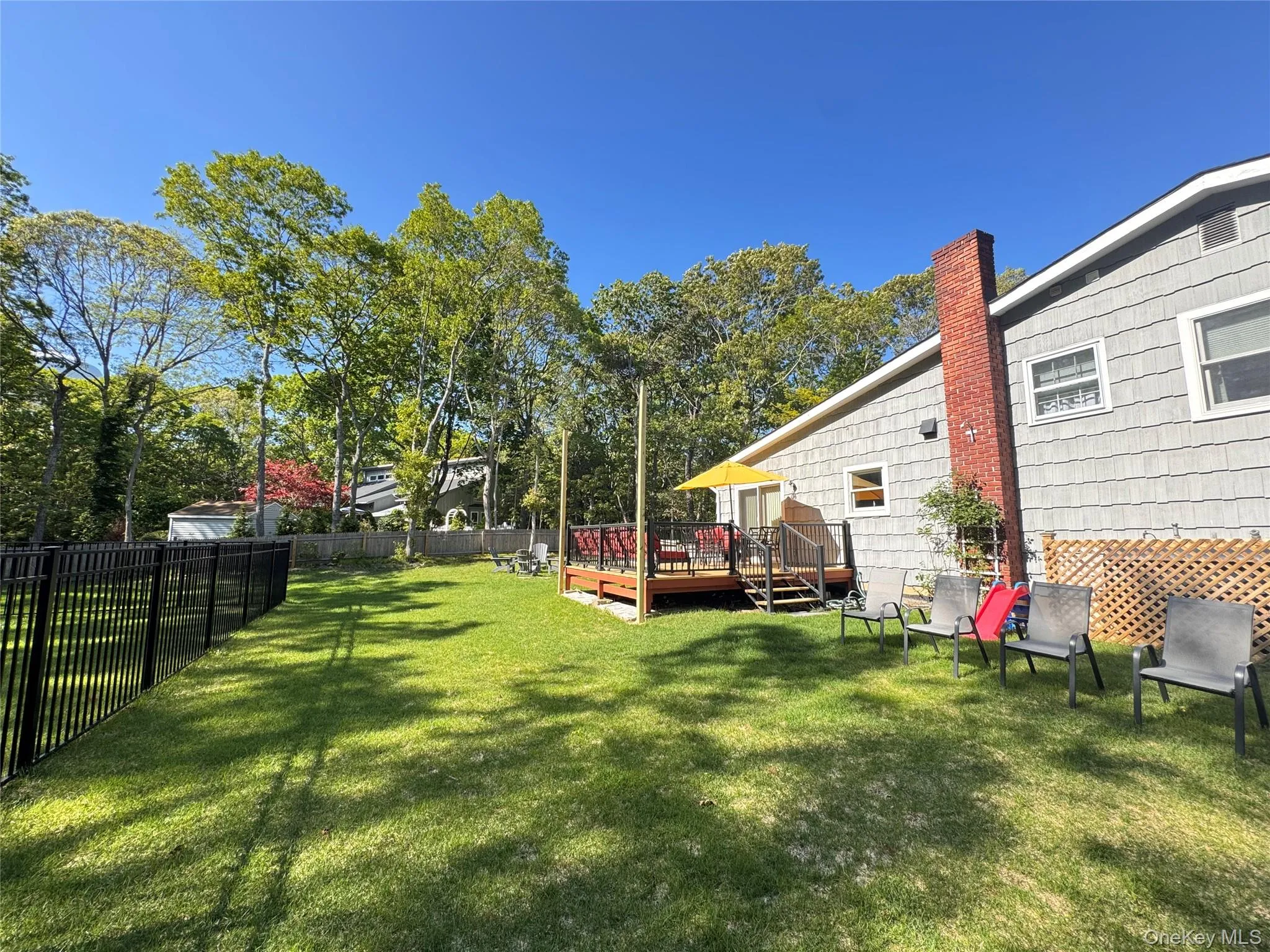View of yard with a wooden deck View of yard with a wooden deck