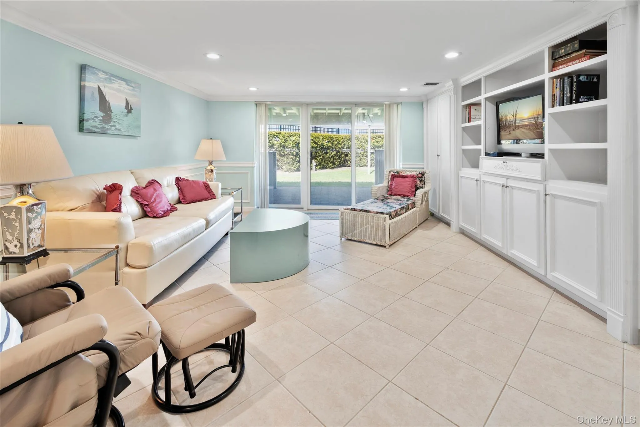Living room with recessed lighting, built in shelves, light tile patterned floors, and crown molding Living room with recessed lighting, built in shelves, light tile patterned floors, and crown molding