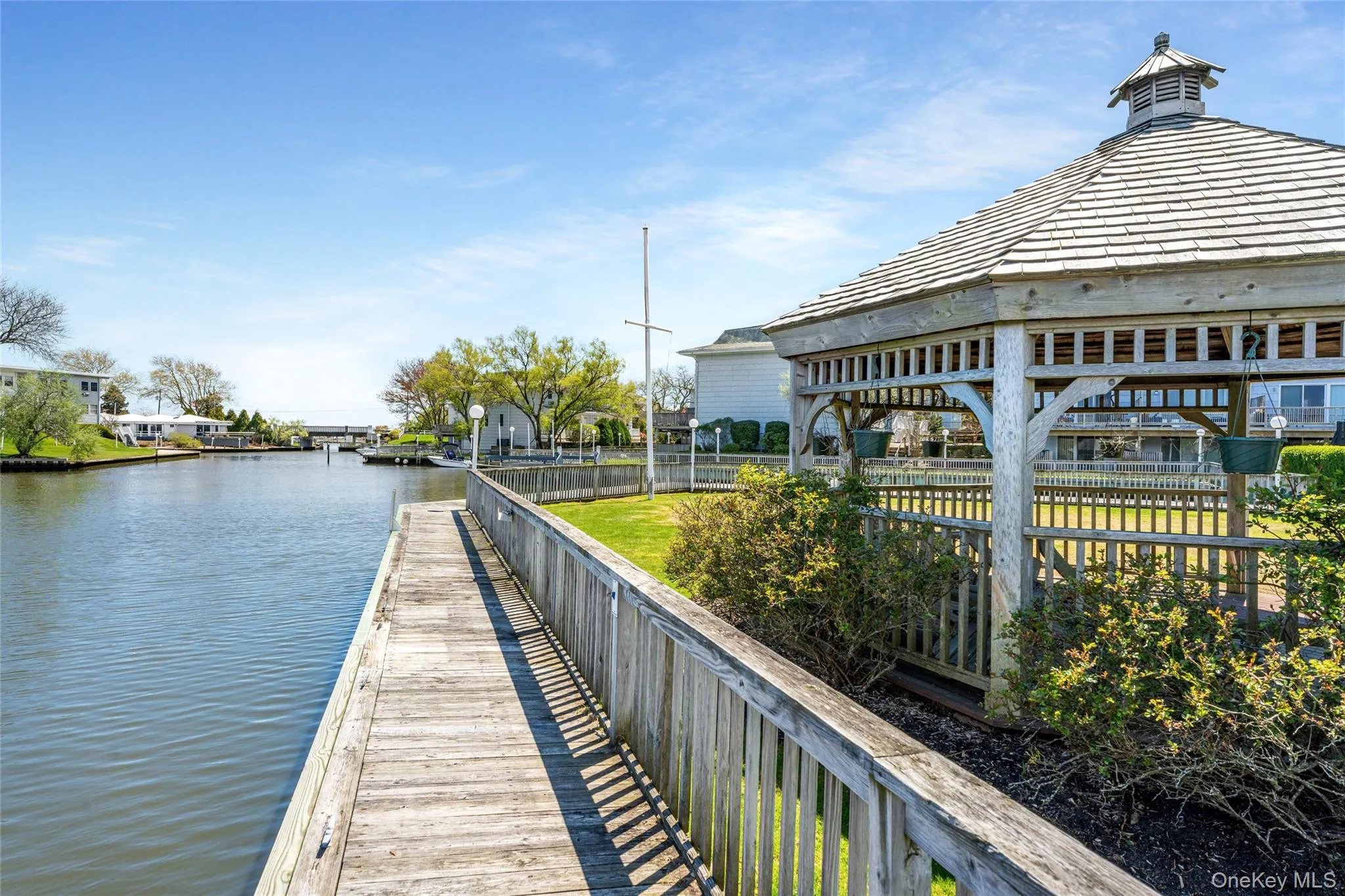 View of dock featuring fence and a water view View of dock featuring fence and a water view