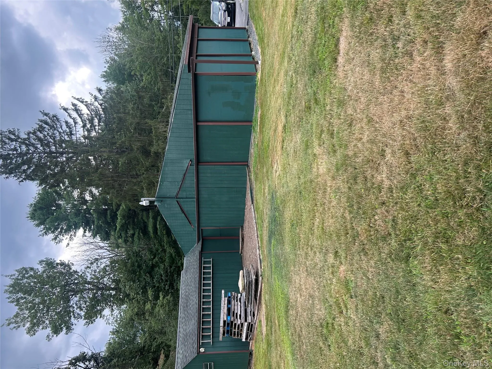 View of pole building featuring a yard View of pole building featuring a yard
