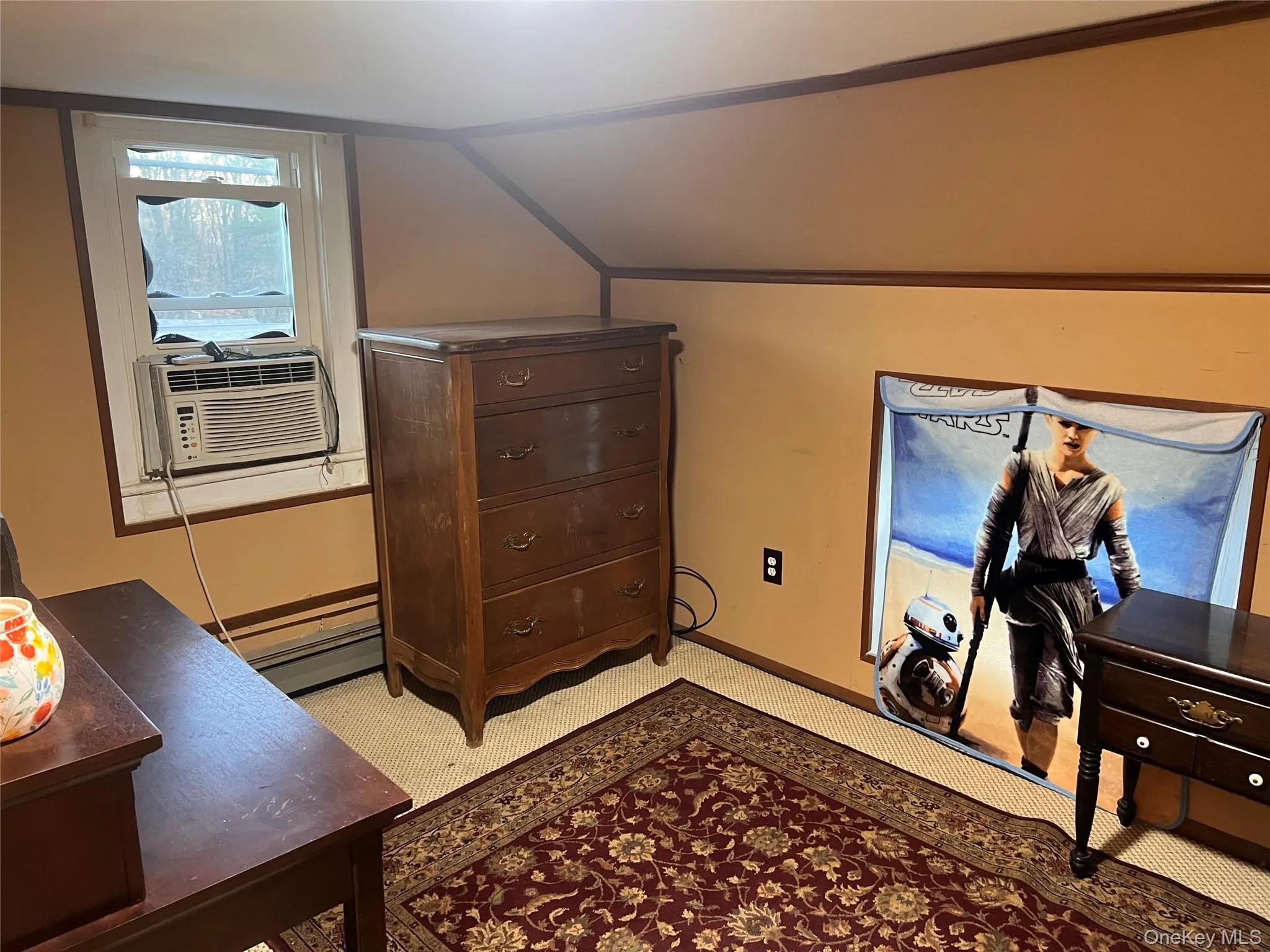 Bedroom with lofted ceiling, cooling unit, and light carpet Bedroom with lofted ceiling, cooling unit, and light carpet