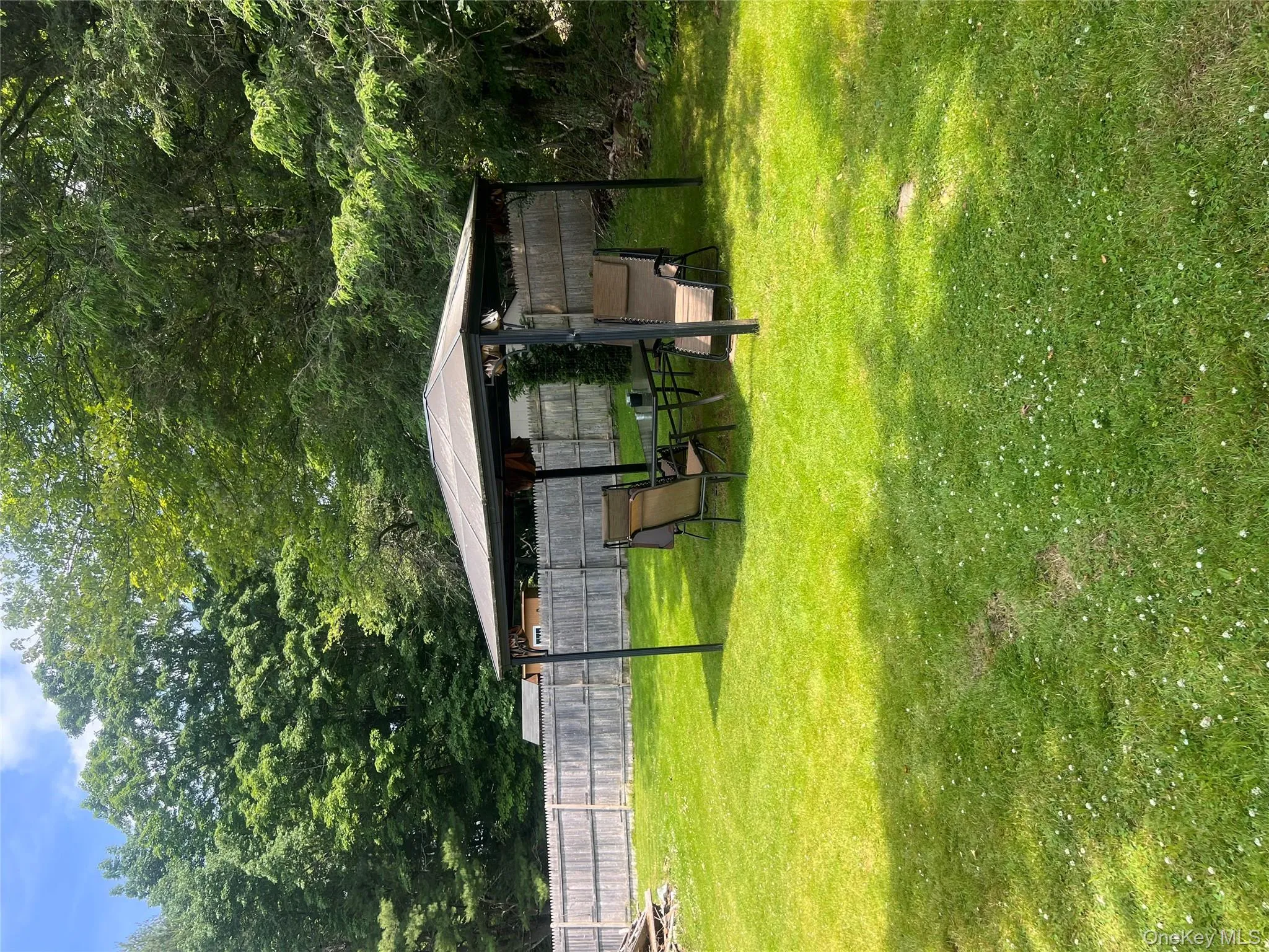 View of yard with a gazebo and view of scattered trees View of yard with a gazebo and view of scattered trees