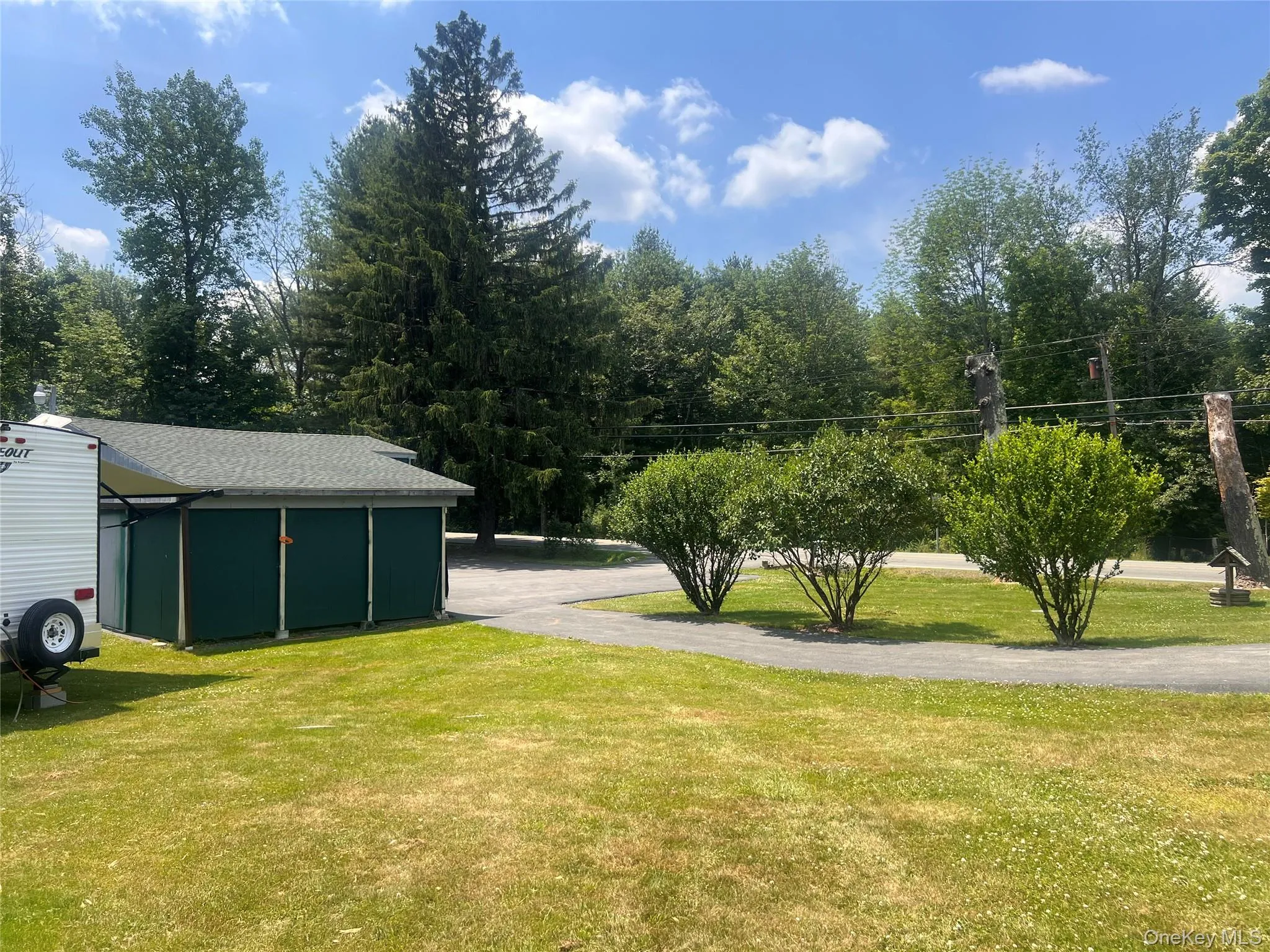View of grassy yard featuring an outdoor structure View of grassy yard featuring an outdoor structure