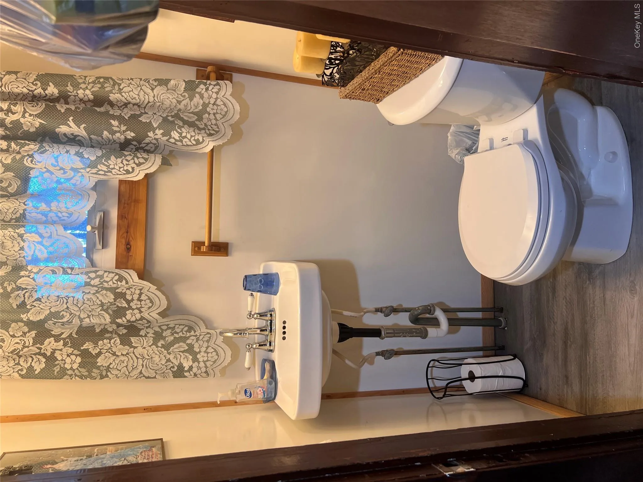 Half bathroom with dark wood-style floors and toilet Half bathroom with dark wood-style floors and toilet