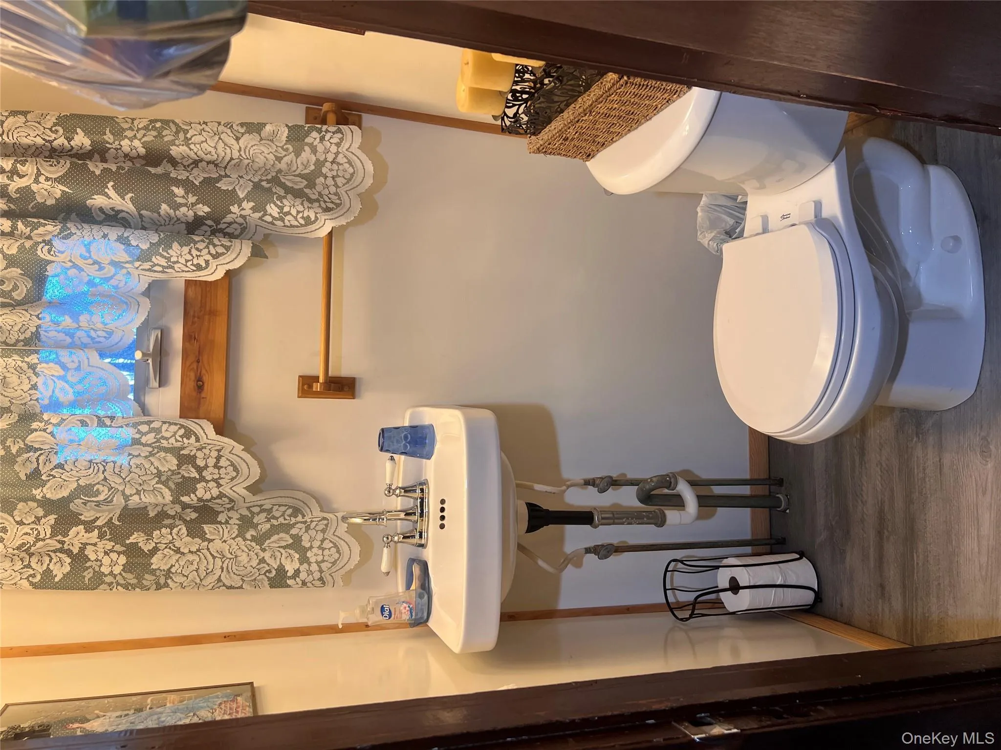 Half bathroom with dark wood-style floors and toilet Half bathroom with dark wood-style floors and toilet