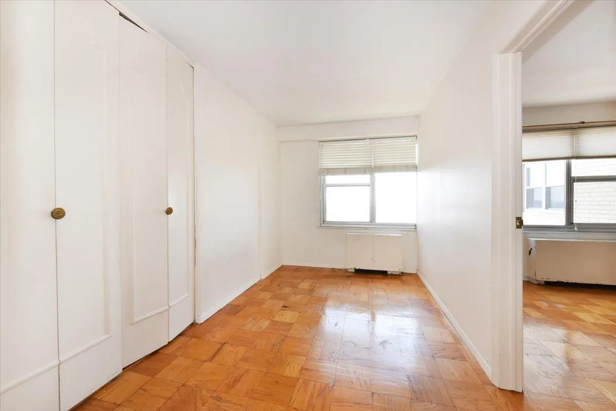 Unfurnished bedroom featuring baseboards and radiator Unfurnished bedroom featuring baseboards and radiator