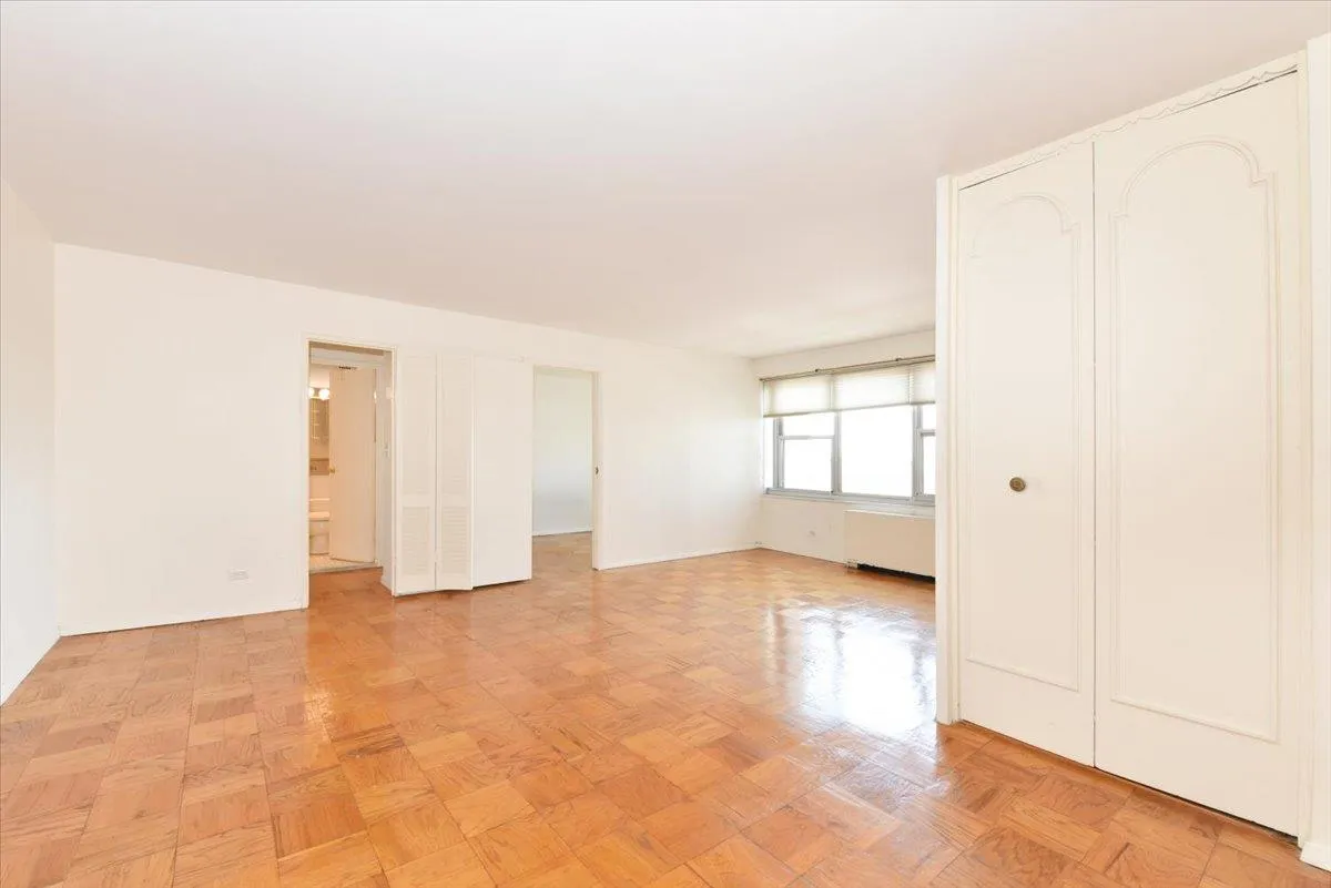 Unfurnished bedroom featuring baseboards and radiator Unfurnished bedroom featuring baseboards and radiator