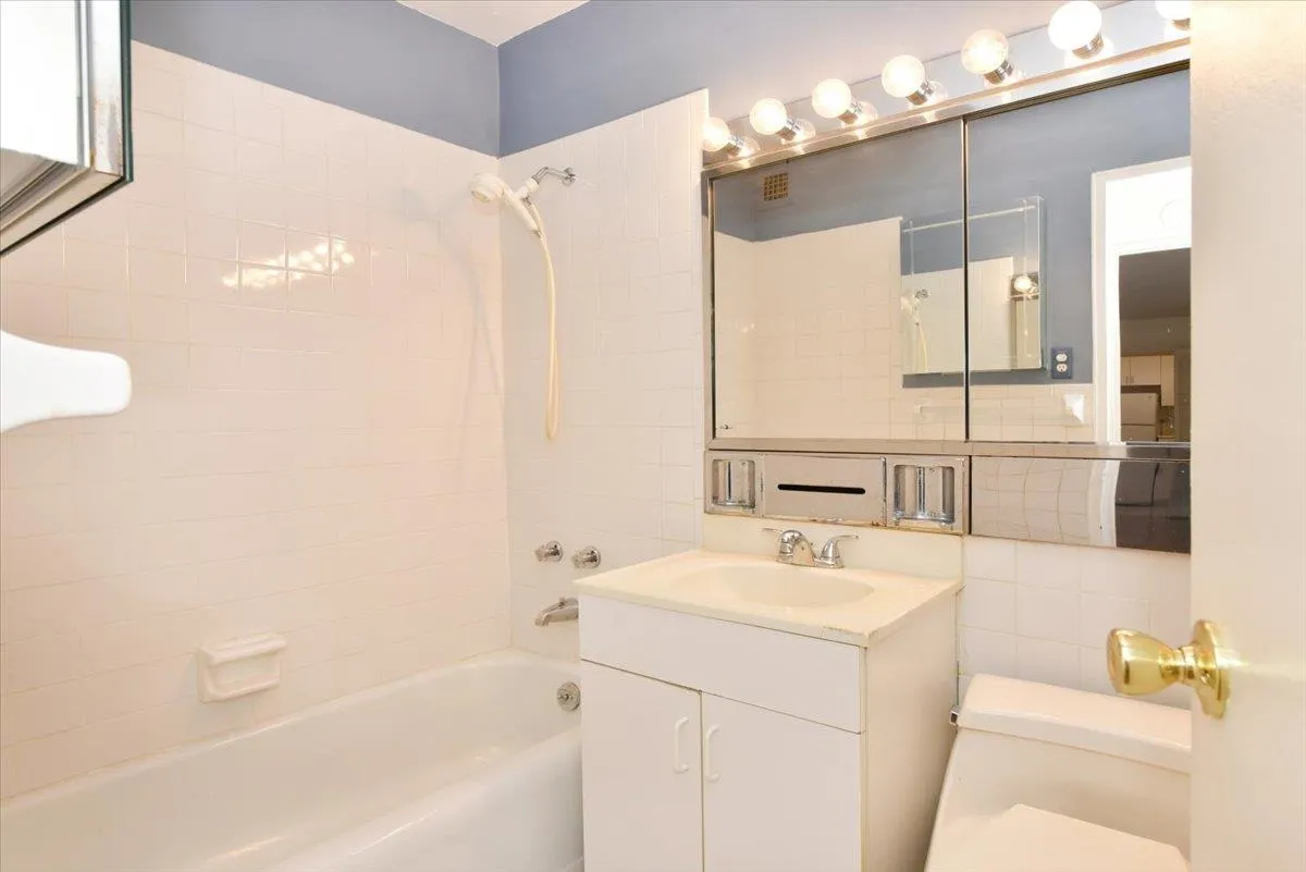 Bathroom with toilet, bathtub / shower combination, and vanity Bathroom with toilet, bathtub / shower combination, and vanity