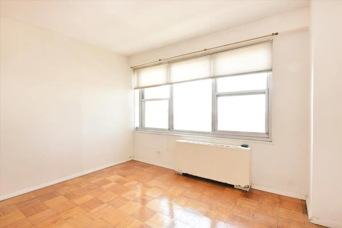 Empty room featuring baseboards and radiator Empty room featuring baseboards and radiator