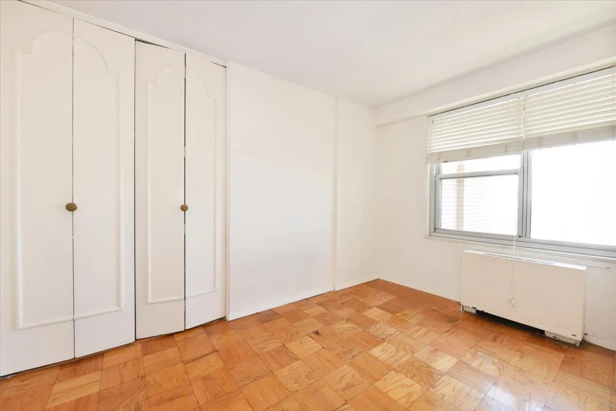 Unfurnished bedroom with radiator heating unit Unfurnished bedroom with radiator heating unit