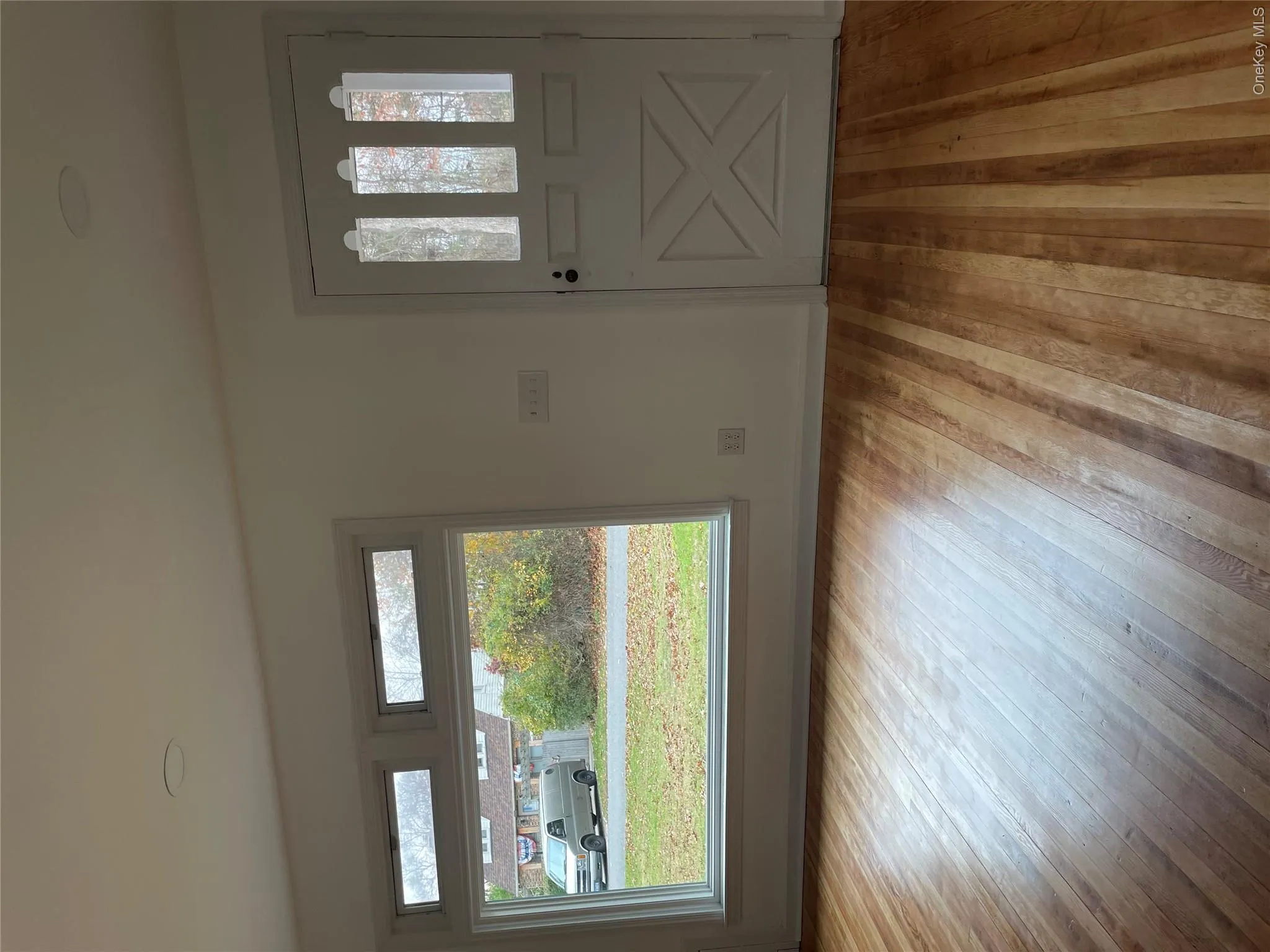 Foyer entrance featuring healthy amount of natural light and light wood-type flooring Foyer entrance featuring healthy amount of natural light and light wood-type flooring