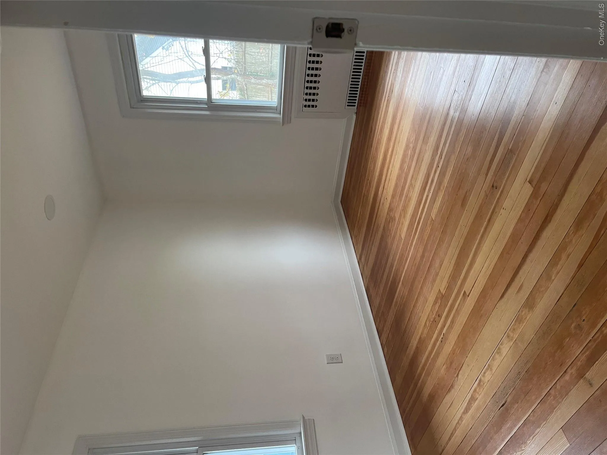 Spare room with light wood-style flooring and radiator heating unit Spare room with light wood-style flooring and radiator heating unit