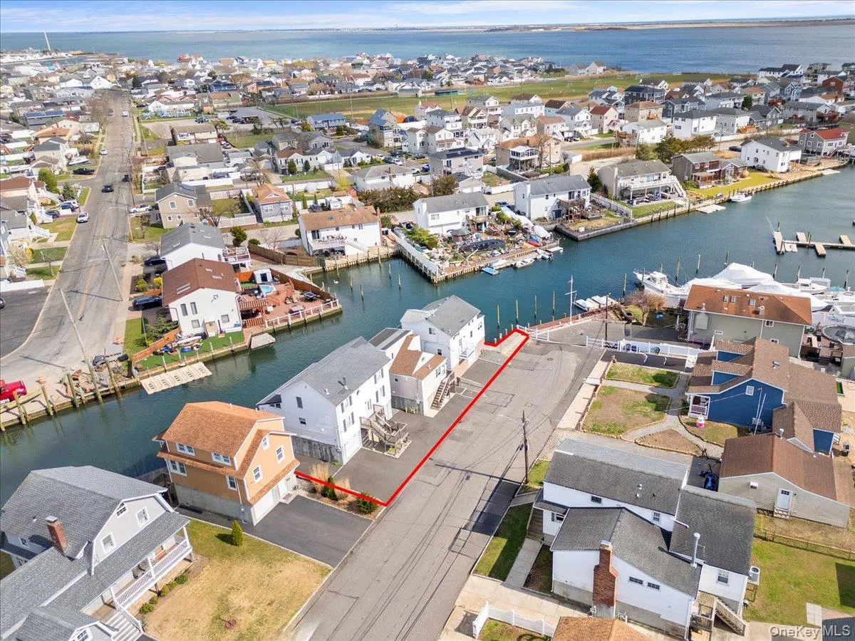Drone / aerial view featuring a residential view and a water view Drone / aerial view featuring a residential view and a water view