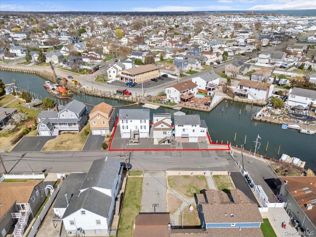 Drone / aerial view featuring a residential view and a water view Drone / aerial view featuring a residential view and a water view