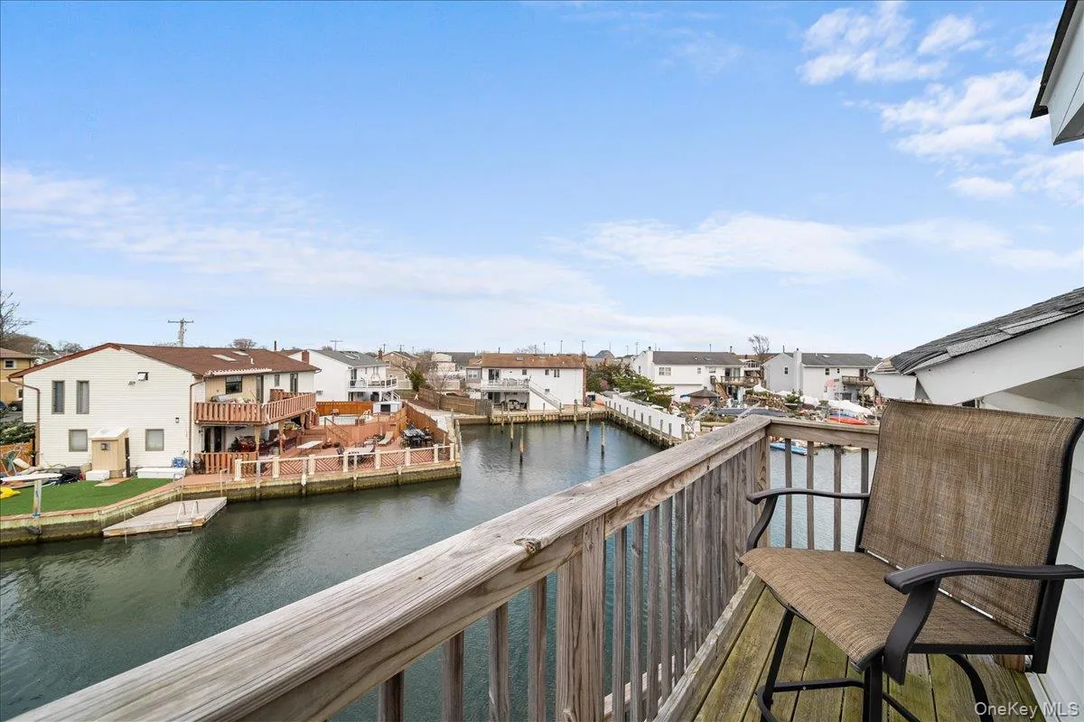 Balcony featuring a water view and a residential view Balcony featuring a water view and a residential view