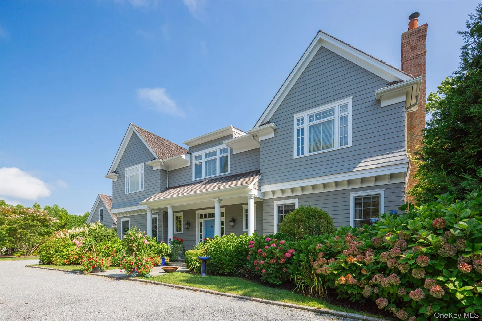 View of front of property with a porch, a chimney, and a shingled roof View of front of property with a porch, a chimney, and a shingled roof
