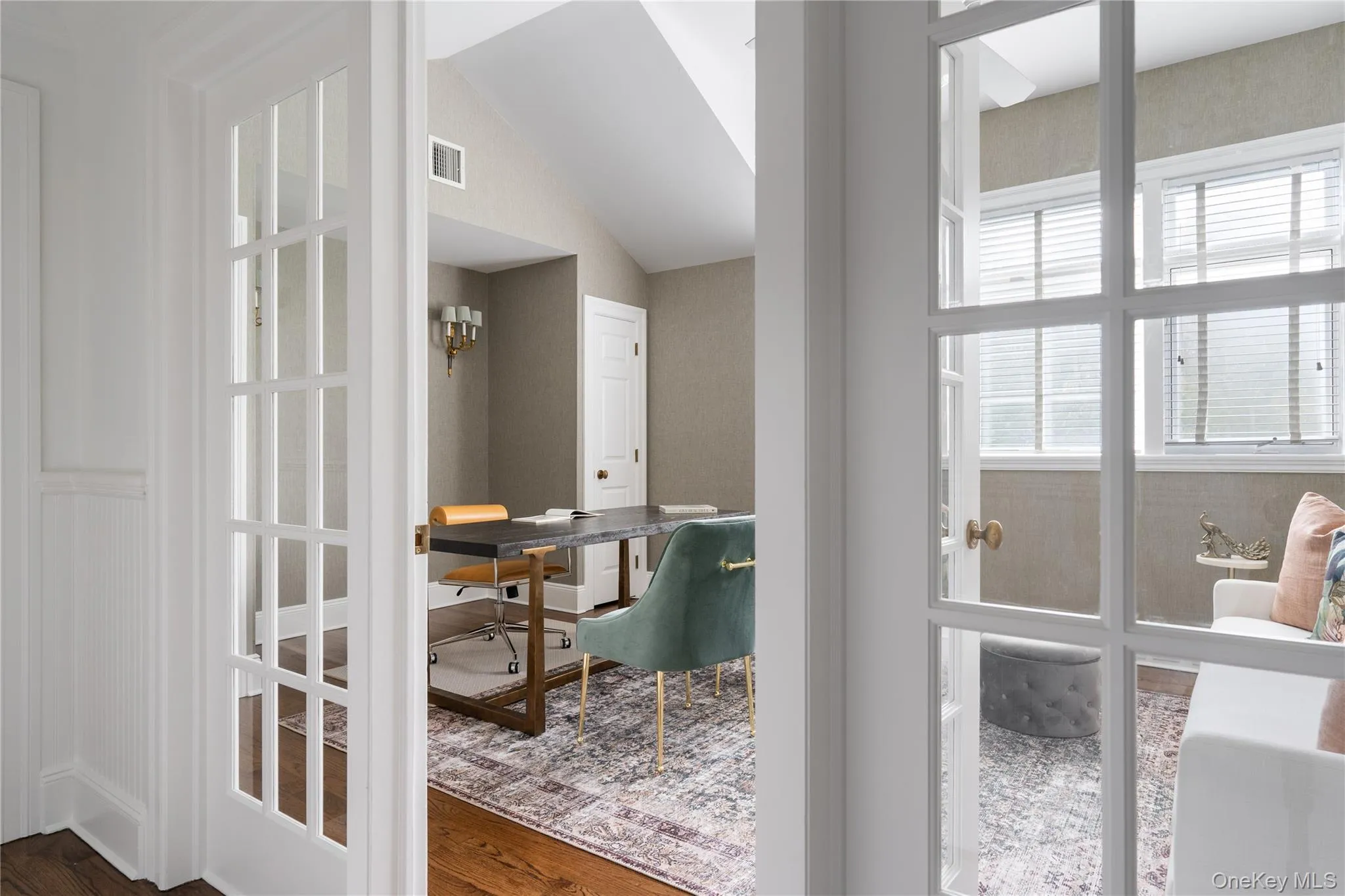 Doorway to outside with wood finished floors, vaulted ceiling, and visible vents Doorway to outside with wood finished floors, vaulted ceiling, and visible vents