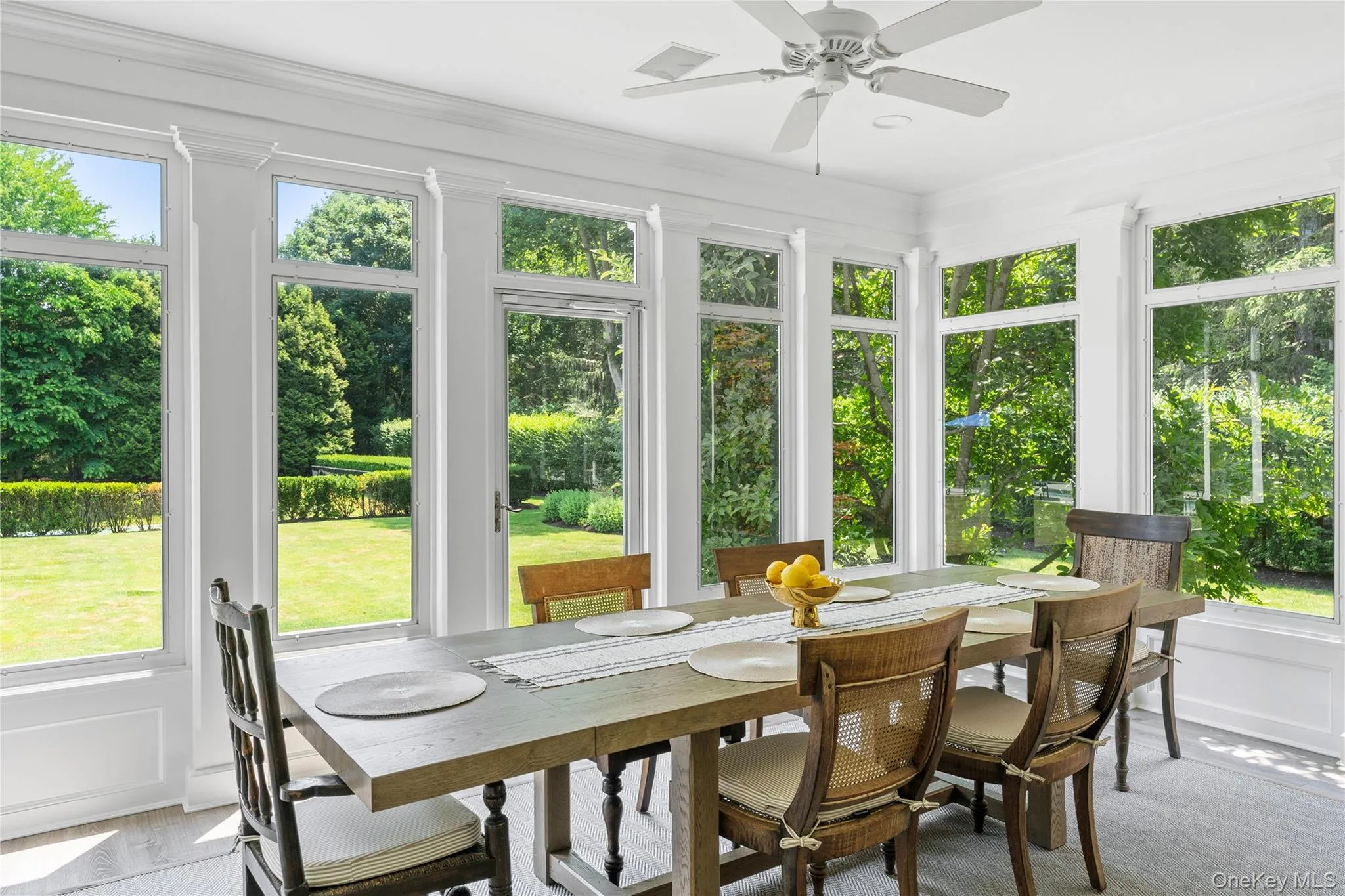 Sunroom / solarium featuring crown molding and a healthy amount of sunlight Sunroom / solarium featuring crown molding and a healthy amount of sunlight