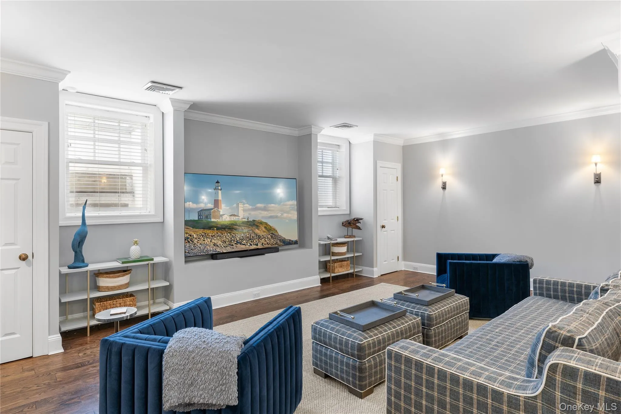 Living area with visible vents, baseboards, wood finished floors, and ornamental molding Living area with visible vents, baseboards, wood finished floors, and ornamental molding