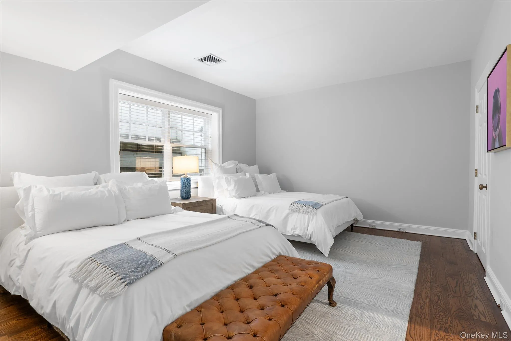 Bedroom with baseboards, visible vents, and dark wood-style flooring Bedroom with baseboards, visible vents, and dark wood-style flooring