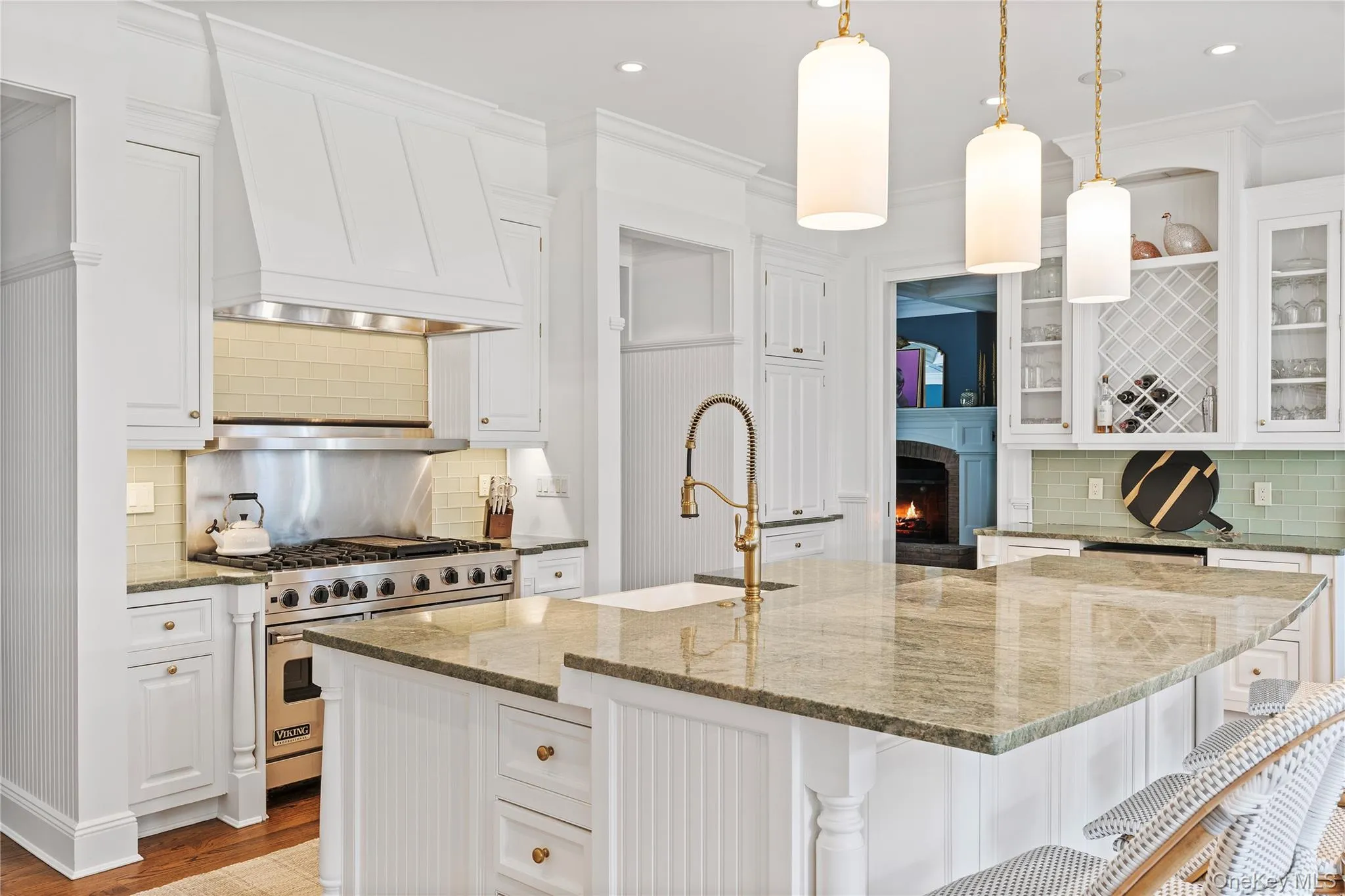 Kitchen with premium stove, a sink, and white cabinetry Kitchen with premium stove, a sink, and white cabinetry