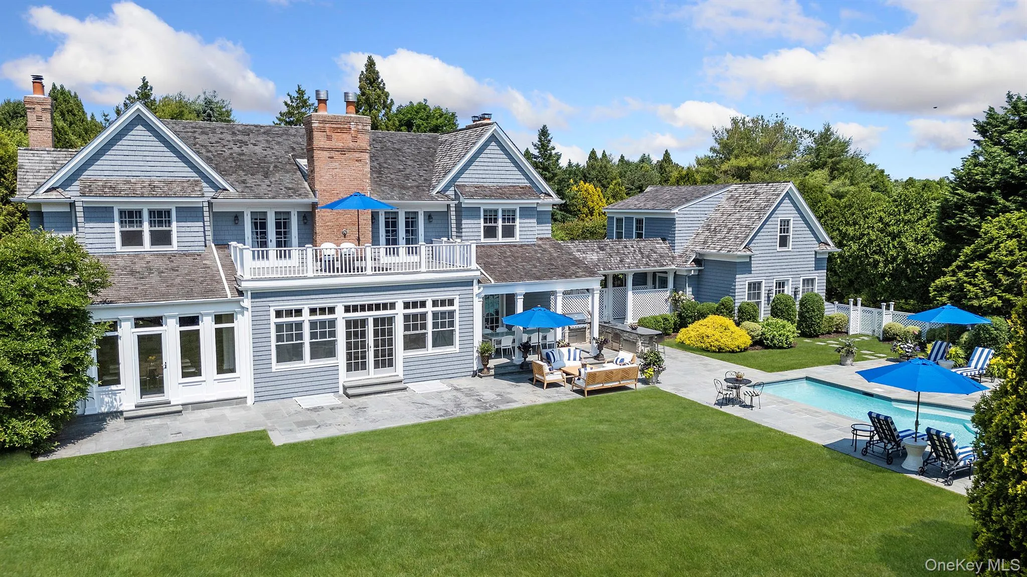 Back of property featuring outdoor lounge area, a patio area, a chimney, and a balcony Back of property featuring outdoor lounge area, a patio area, a chimney, and a balcony
