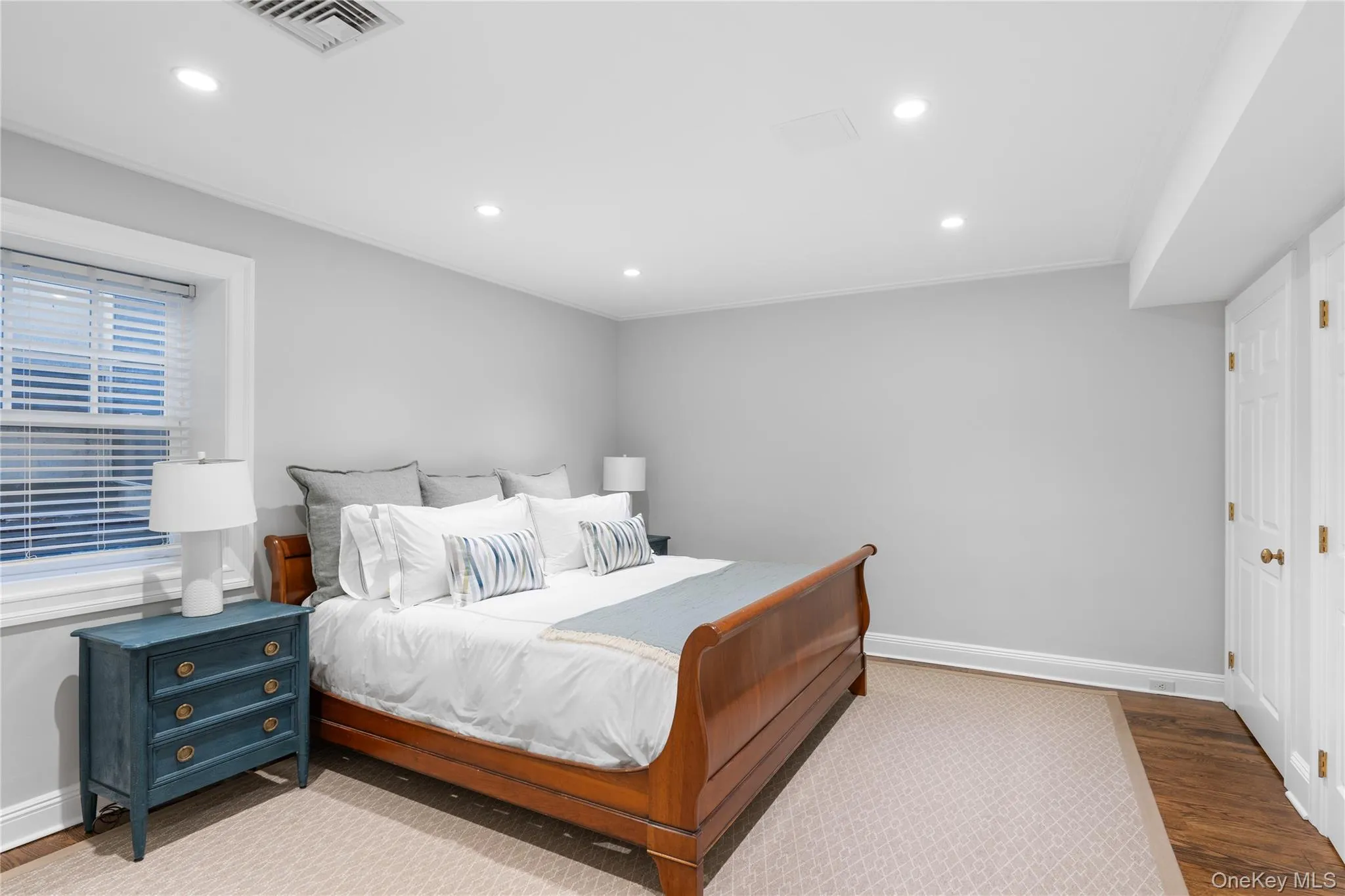 Bedroom featuring baseboards, wood finished floors, visible vents, and recessed lighting Bedroom featuring baseboards, wood finished floors, visible vents, and recessed lighting