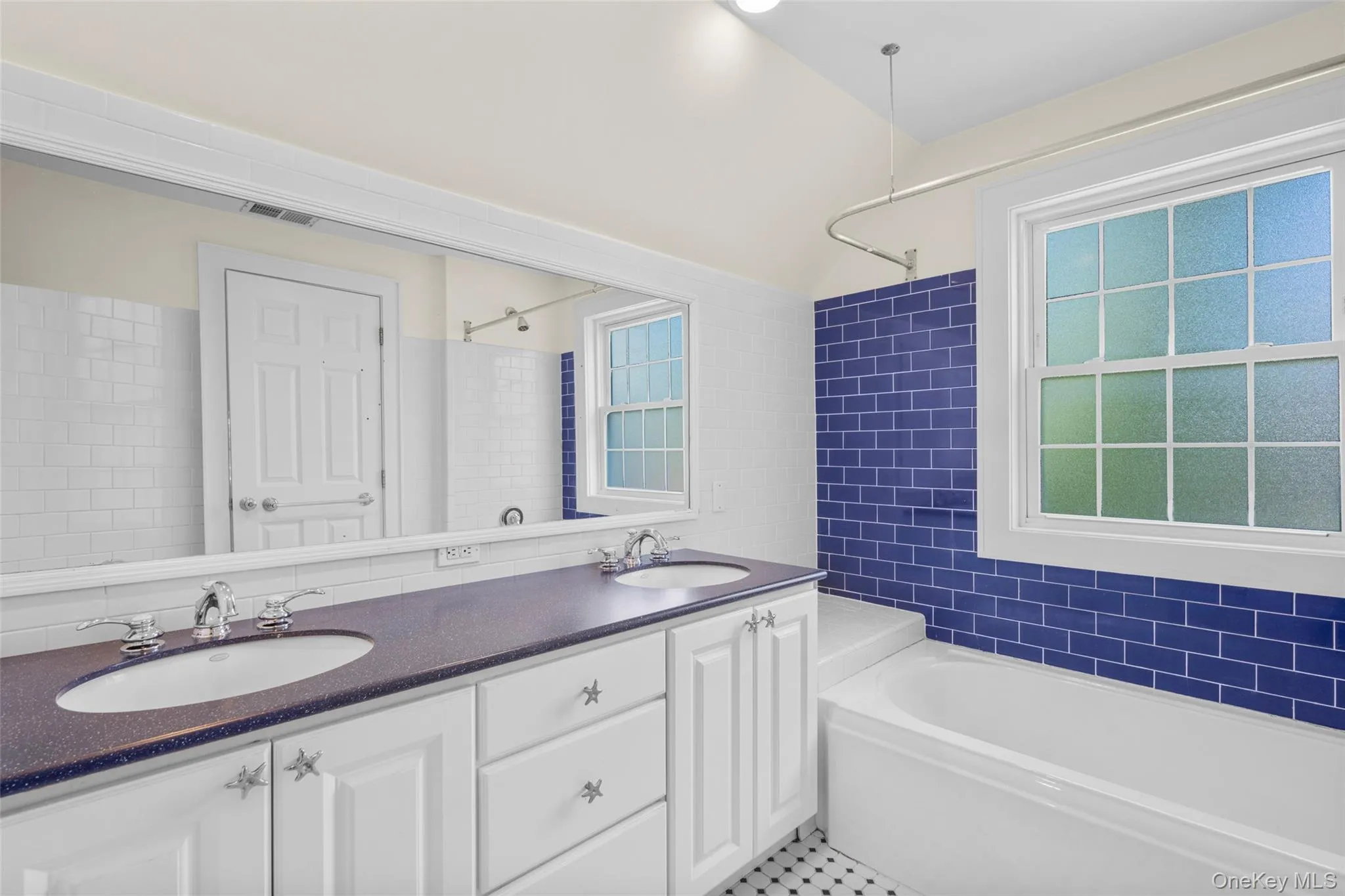 Hall bathroom with tub and 2 sink vanity. Hall bathroom with tub and 2 sink vanity.